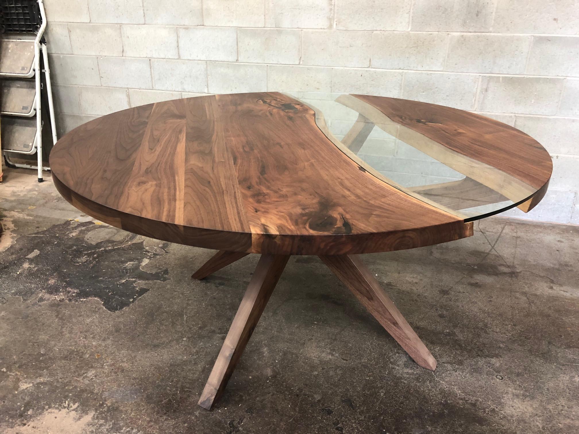 This round black walnut dining table on black walnut legs is the perfect nook table. It sits comfortably 4-5 people for a 66in diameter and more depending on the size. Each table is different because of the live edge of the slabs. We use tempered