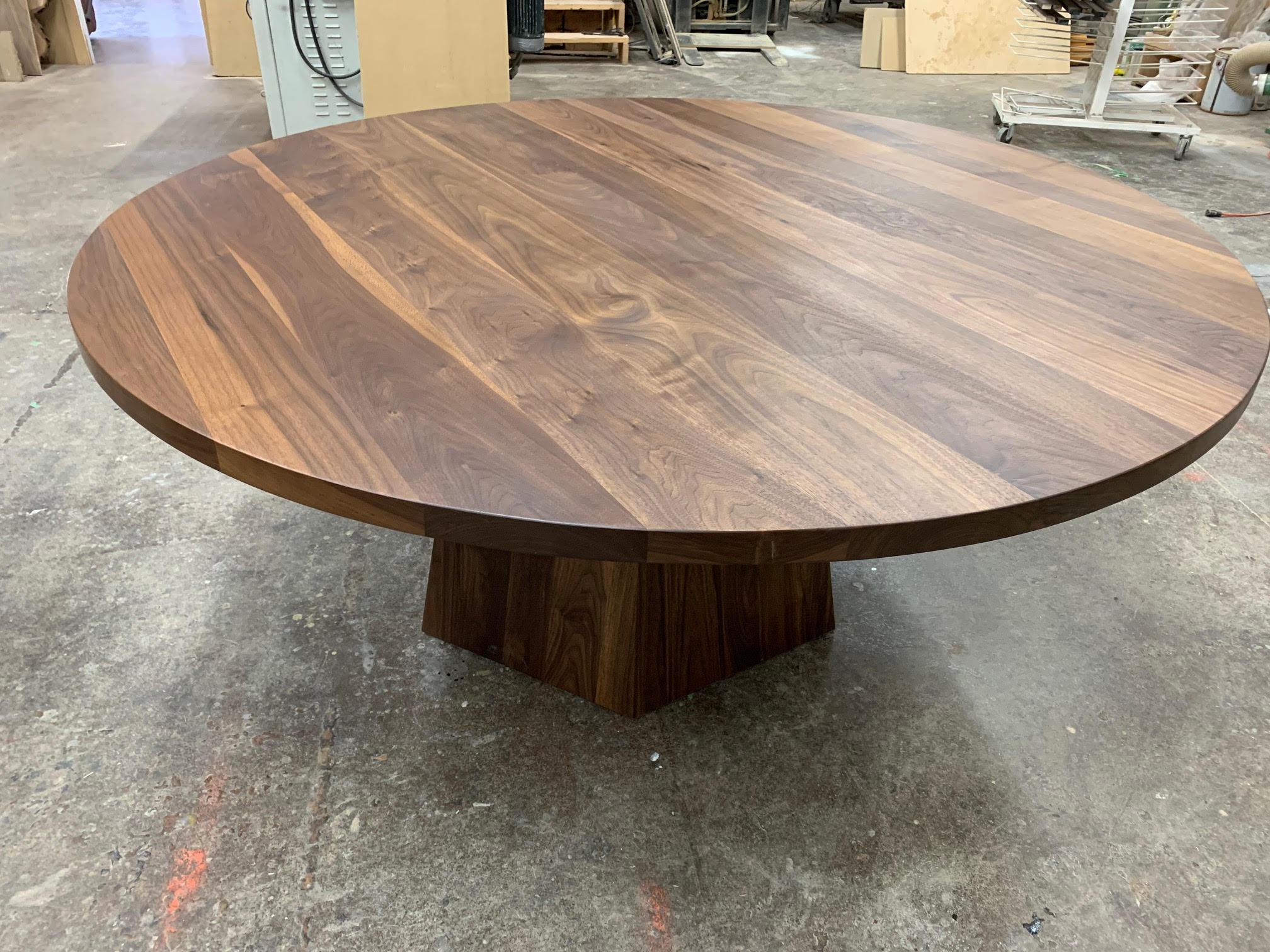 This round black walnut dining table on black walnut hexagonal base with brass is the perfect dining table. It sits comfortably 4-5 people for a 66in diameter and more depending on the size. The brass adds a note of glamour to the table. Our motto,