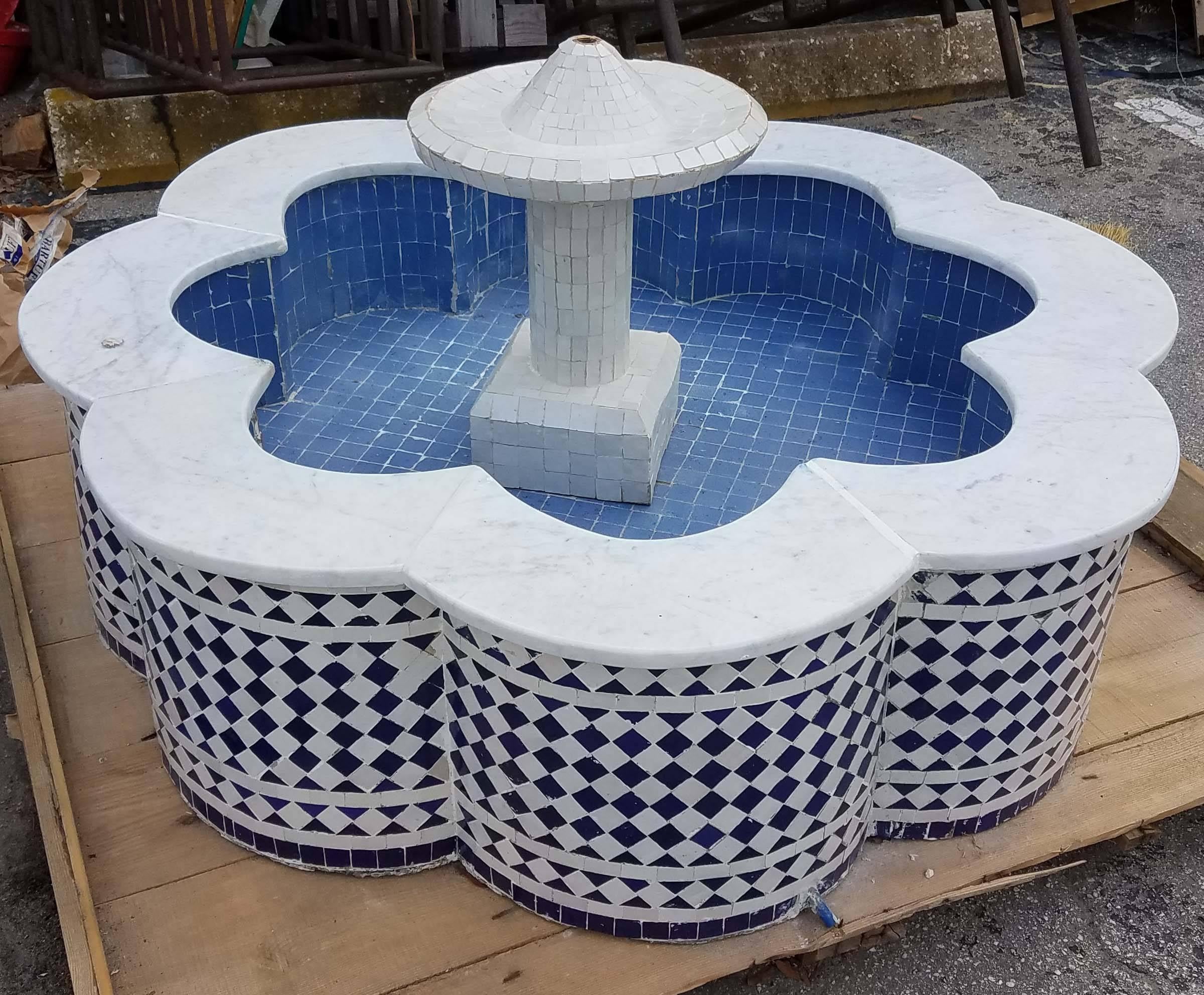 This is a typical Moroccan Mosaic fountain handmade in Marrakech. This fountain is usually found in courtyards and Riads all over Morocco. It measures approximately 50 in diameter and 22 in height and weighs about 325 lbs. Please contact us if you