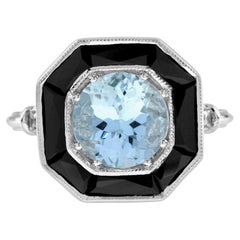 Anillo de oro blanco de 14 quilates estilo Art Déco con halo de ónice negro y aguamarina azul redonda