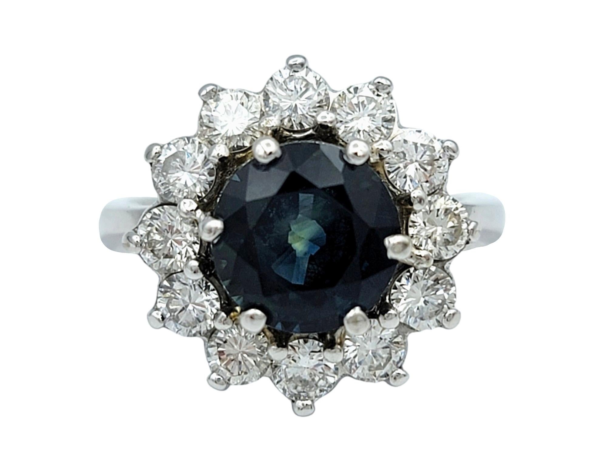 Ring Size: 5

This gorgeous round blue sapphire with diamond halo cocktail ring, set in luxurious 14 karat white gold, is a mesmerizing symbol of sophistication and grace. At its center, a captivating blue sapphire gemstone dazzles with its deep hue