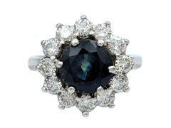 Round Blue Sapphire and Diamond Halo Flower Cocktail Ring in 14 Karat White Gold