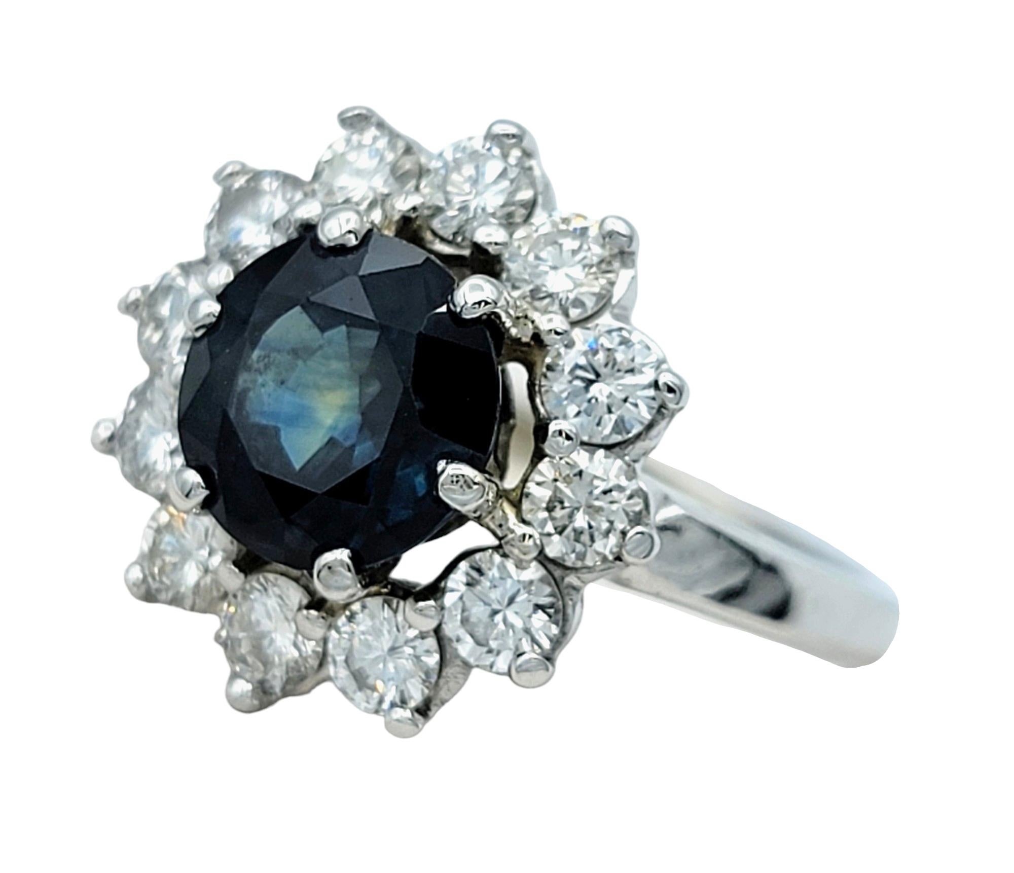 Contemporary Round Blue Sapphire and Diamond Halo Flower Cocktail Ring in 14 Karat White Gold For Sale