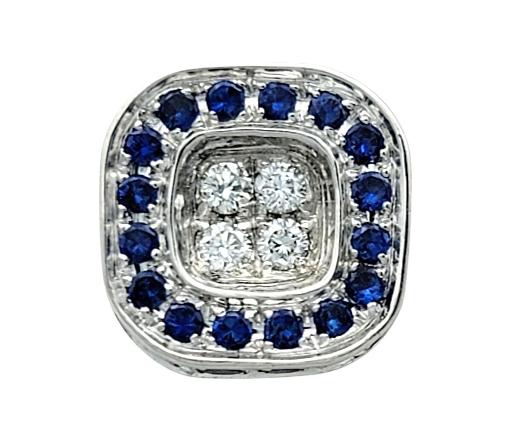 These elegant sapphire and diamond earrings are a perfect combination of sophistication and luxury. Set in radiant 18 karat white gold, each earring features a cluster of round cut diamonds surrounded by a halo of sparkling round-cut blue sapphires.