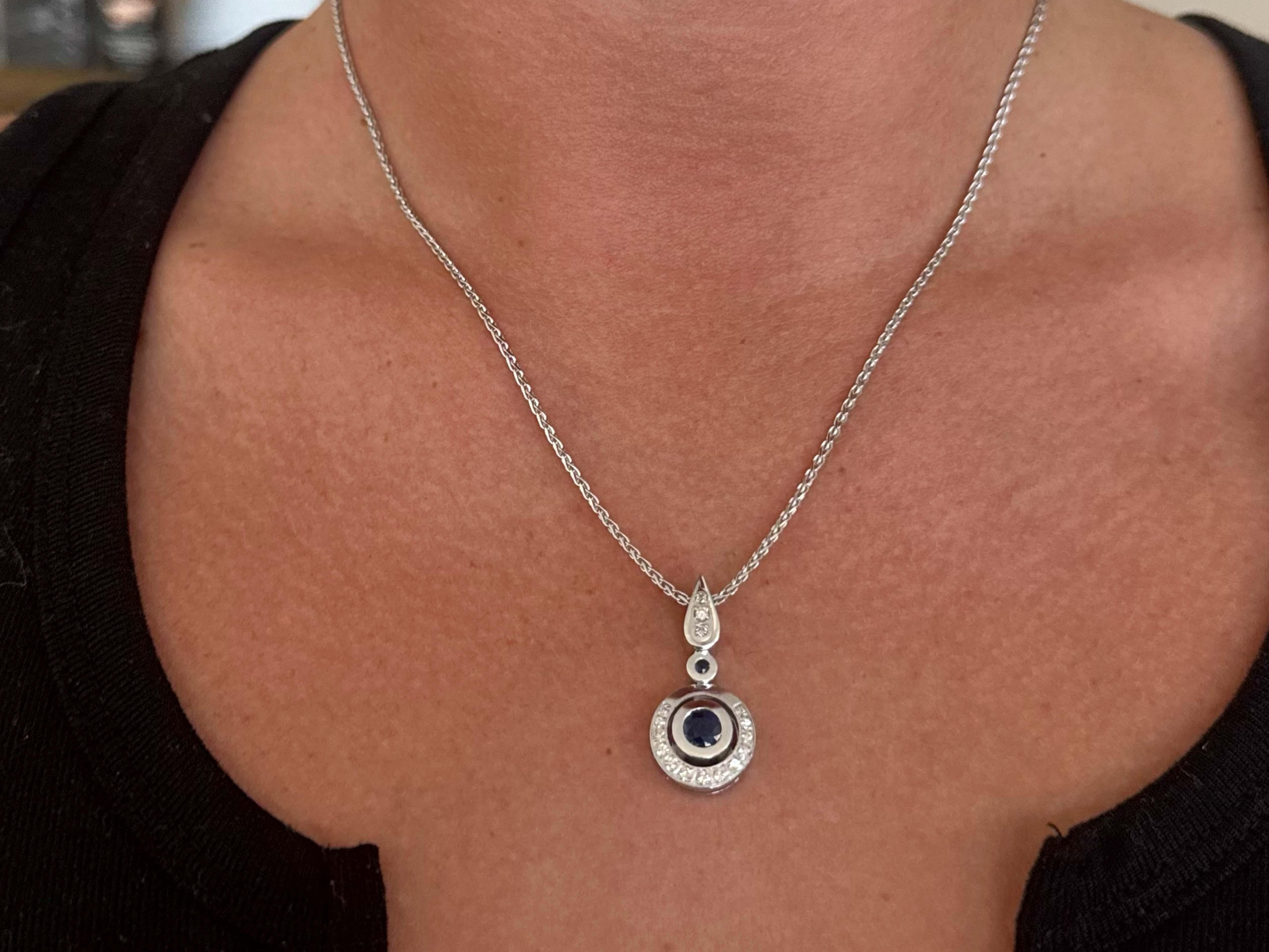 Item Specifications:

Metal: 14k White Gold

Diamond Count: 16 brilliant cut diamonds

Diamond Total Carat Weight: 0.15 carat

Diamond Color: H-J

Diamond Clarity: VS1-SI2

Sapphire Count: 2 round sapphires

Sapphire Color: blue 
​
​Center Sapphire