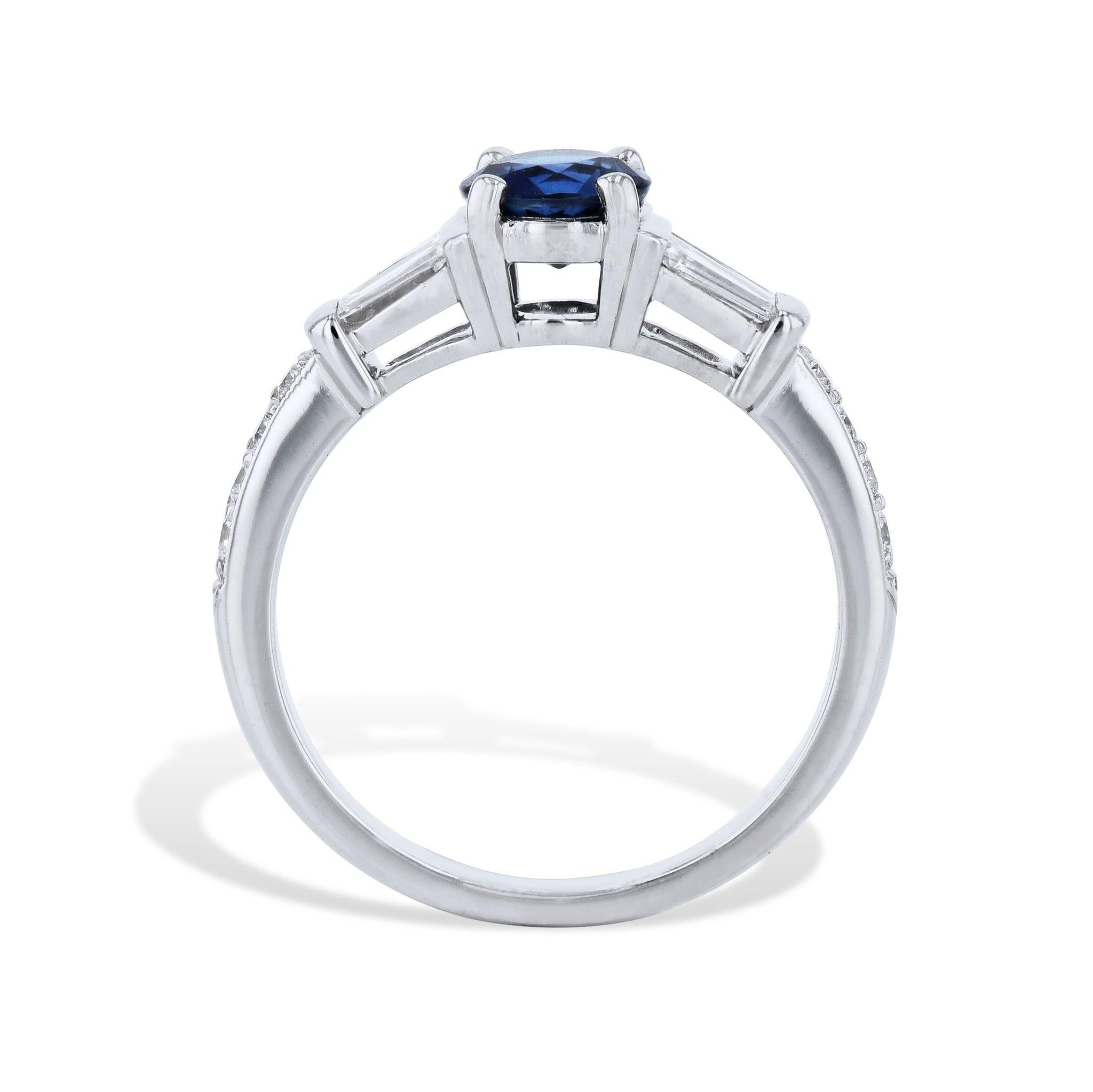 Luxuriate in the beauty of this Round Blue Sapphire Diamond Platinum Estate Ring! Its impressive Sapphire commands attention, while Baguette Diamonds gleam on each side. Pave Diamonds sparkle down the shank. Unforgettable style awaits with this