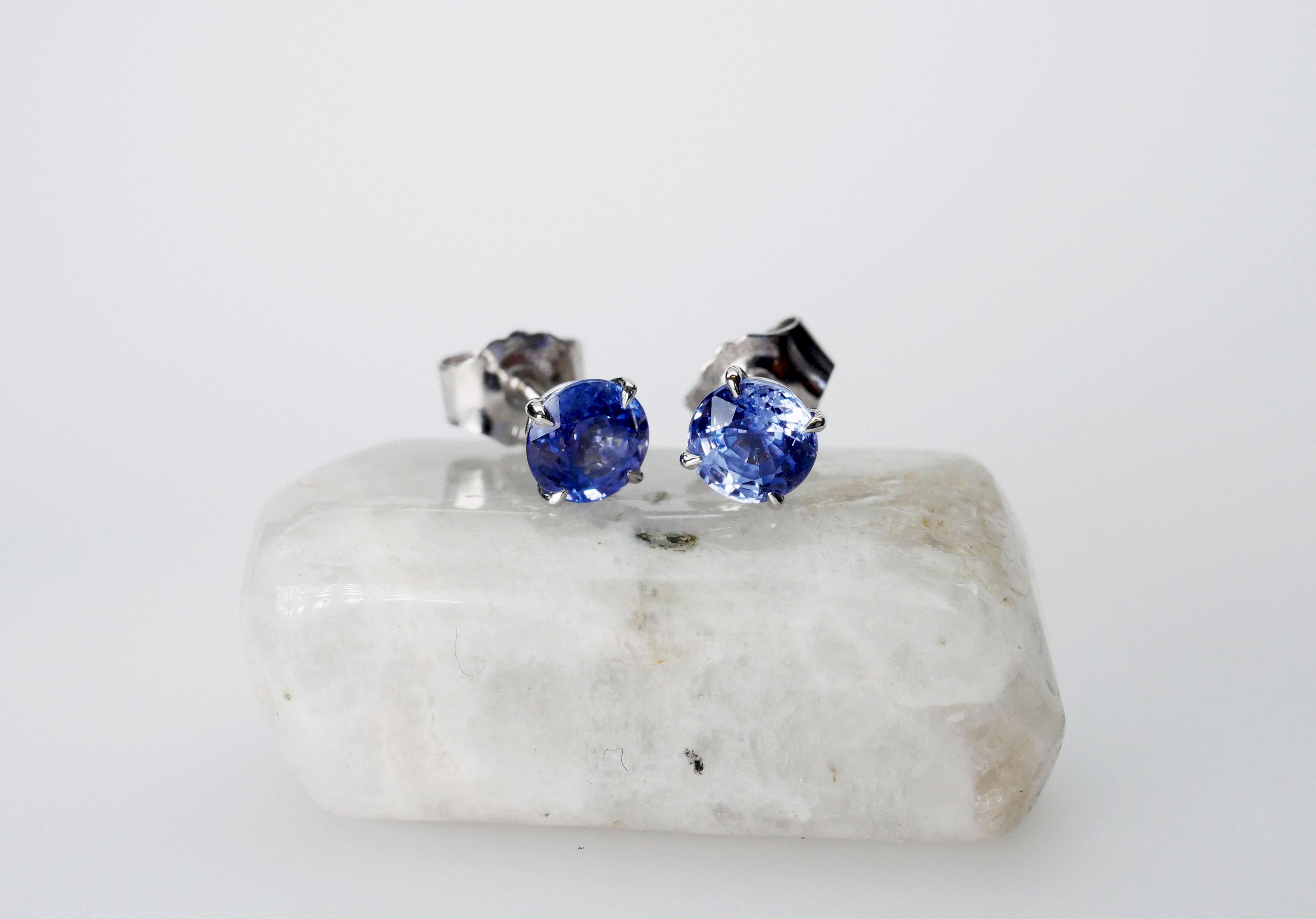 Handmade solitaire light blue round sapphire stud earrings in 18k white gold. Minimal and elegant with talon-shaped claws and an open basket setting, perfect to wear solo or stacked.

Total Sapphire Weight 2/1.16 Carat
