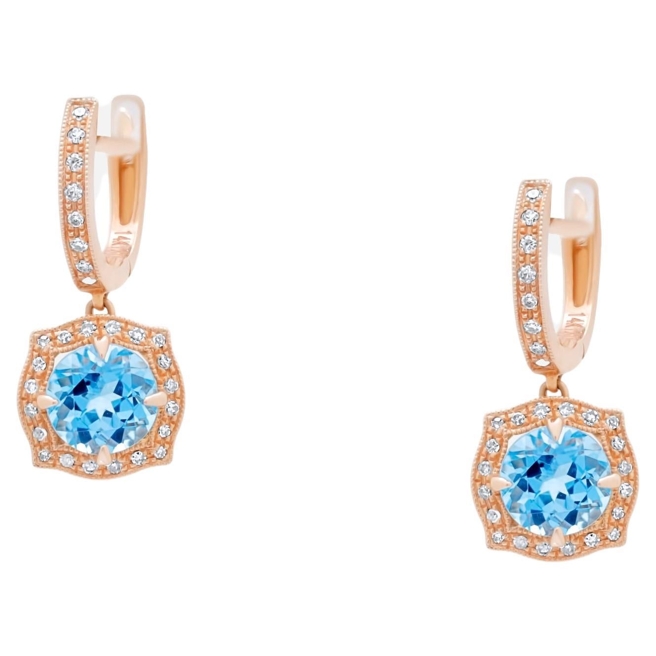 Pendientes redondos de oro rosa de 14 quilates con halo de diamantes y topacio azul