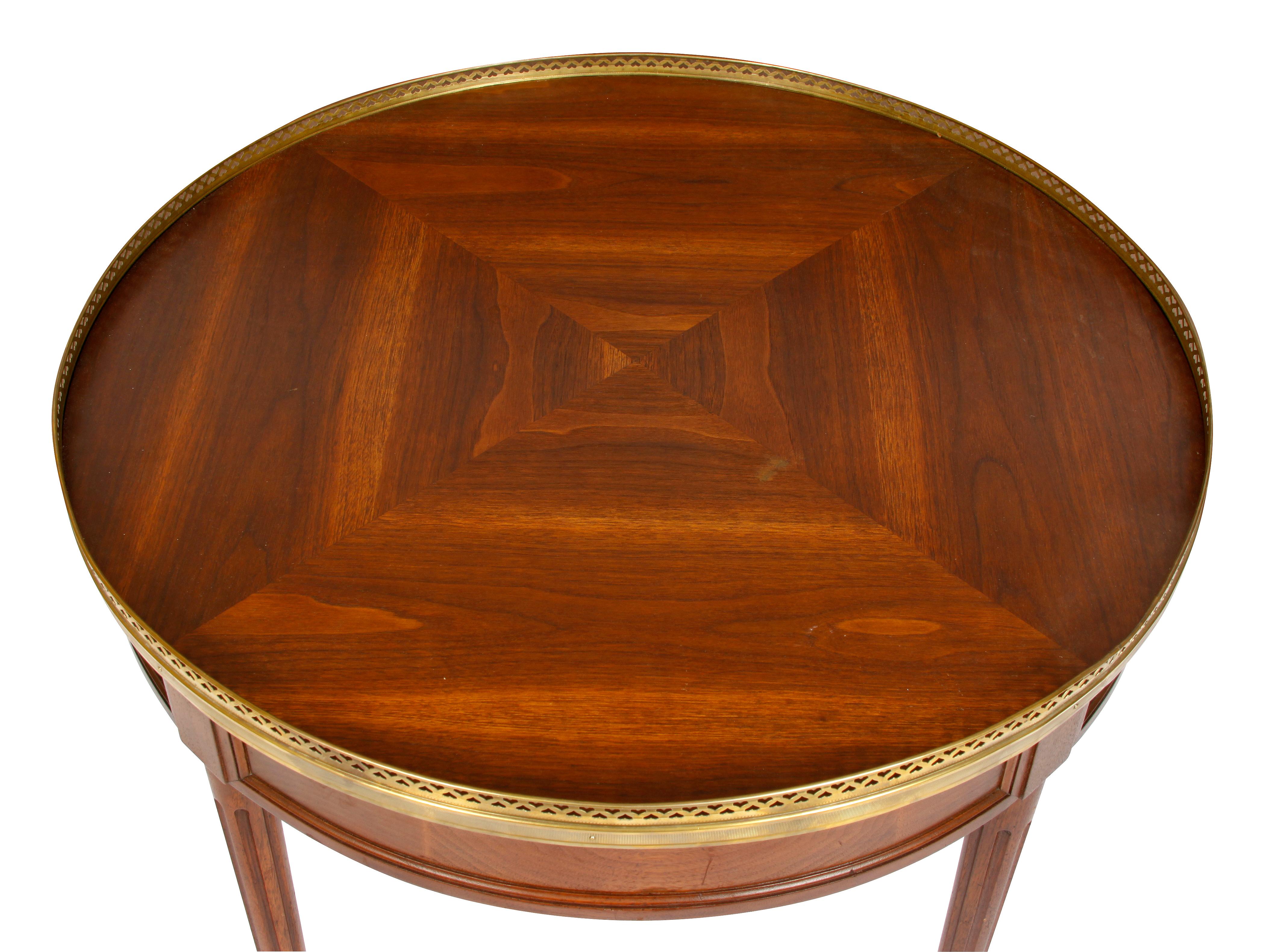 French round bouillotte table with wood top in a concentric square design and brass gallery.