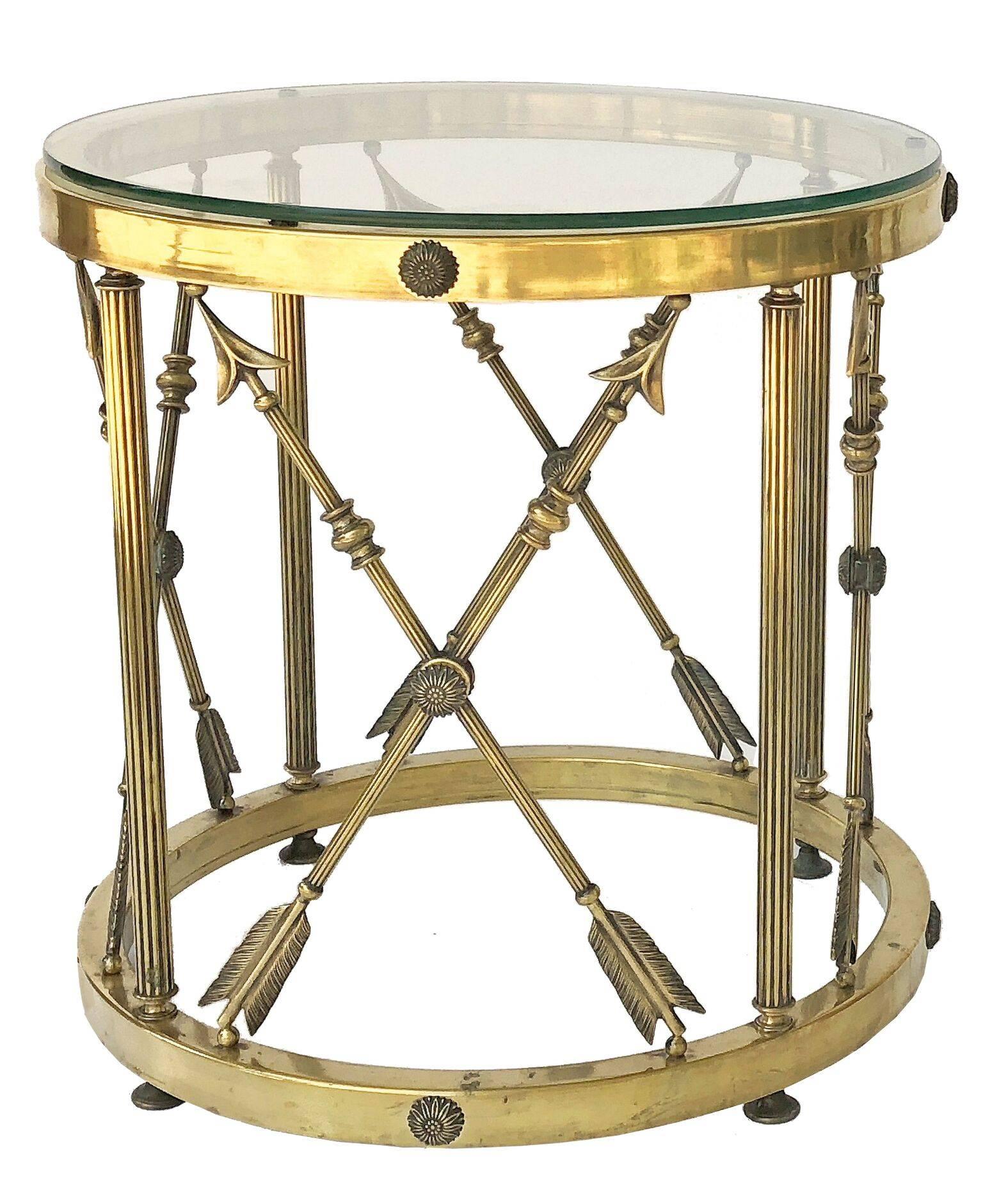 A fine English Neoclassical round occasional table (or side or end table), with a removable round glass top above a circular brass base featuring a design of crossed arrows around the circumference.

