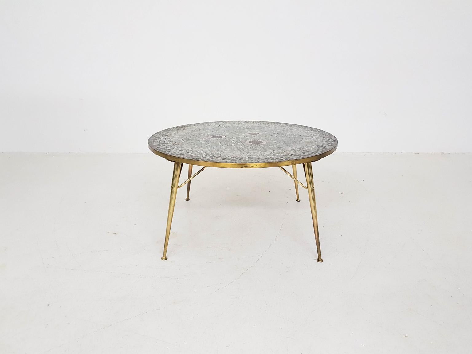 Unique piece of art by German Artist Berthold Müller.

This round mosaic coffee table with its brass legs is the work of the German sculptor Berthold Müller. We think it is one of the most beautiful examples by Müller. With its brass frame it