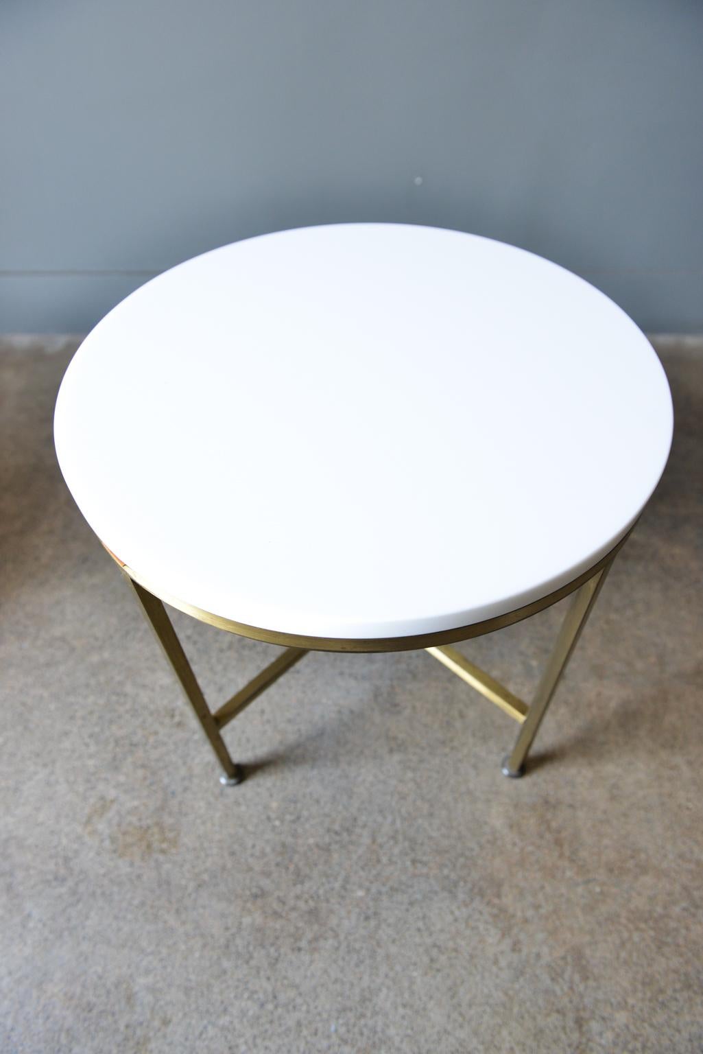 Round brass and Vitrolite side table by Paul McCobb for Directional, circa 1959. Beautiful brass and near perfect vitrolite side table, scarce model not often seen. Brass has some patina and vitrolite has extremely light wear, no chips.

Measures: