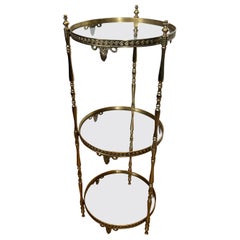Round Brass Gueridon with Three Glass Shelves. French work by Maison Jansen