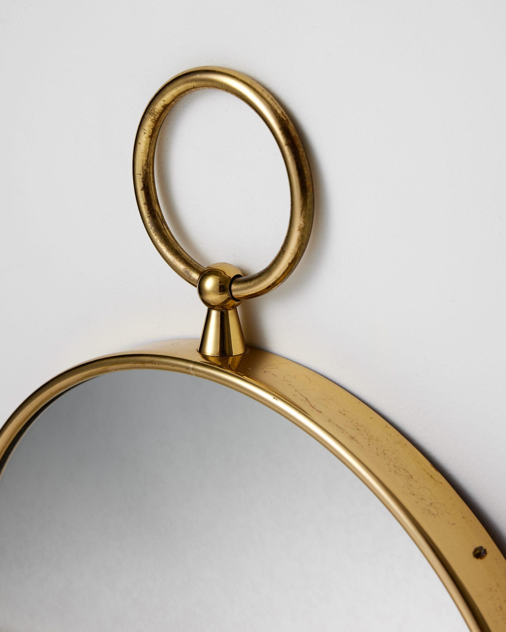 Round brass mirror designed by Piero Fornasetti for Svenskt Tenn, Sweden, 1980s In Good Condition For Sale In Stockholm, SE