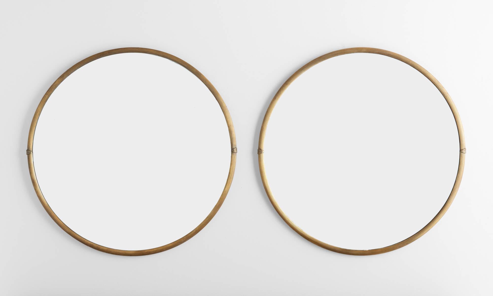 Round Brass Mirror, England circa 1950.

Elegant, sleek forms with brass frames, which include understated detailing.