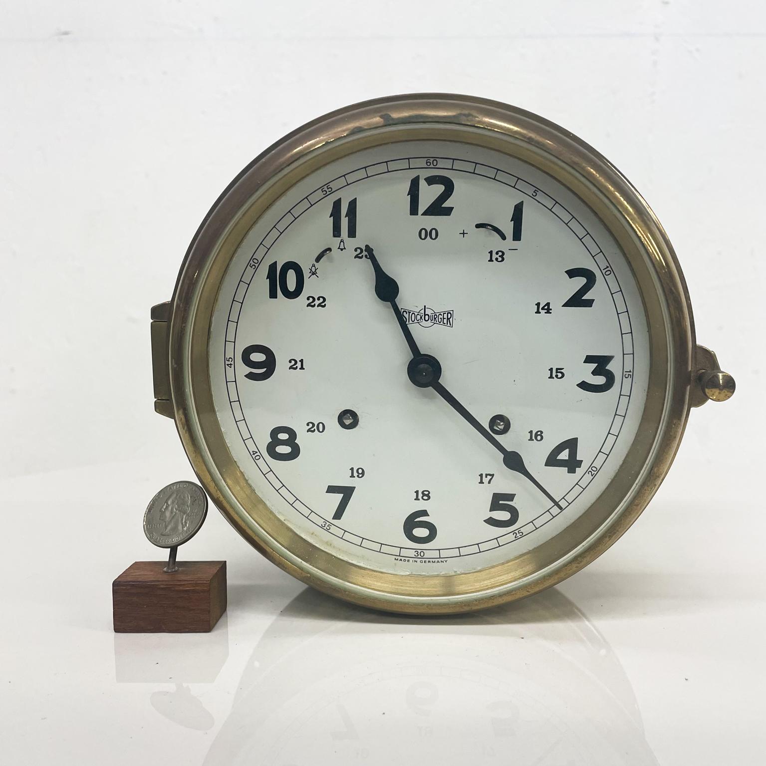 Marine Clock
1960s by Stockburger maritime round brass nautical ship's bell clock West Germany 
Mechanical with winding key
7.5 diameter x 3.75 d
Preowned vintage unrestored condition.
Refer to images.
 