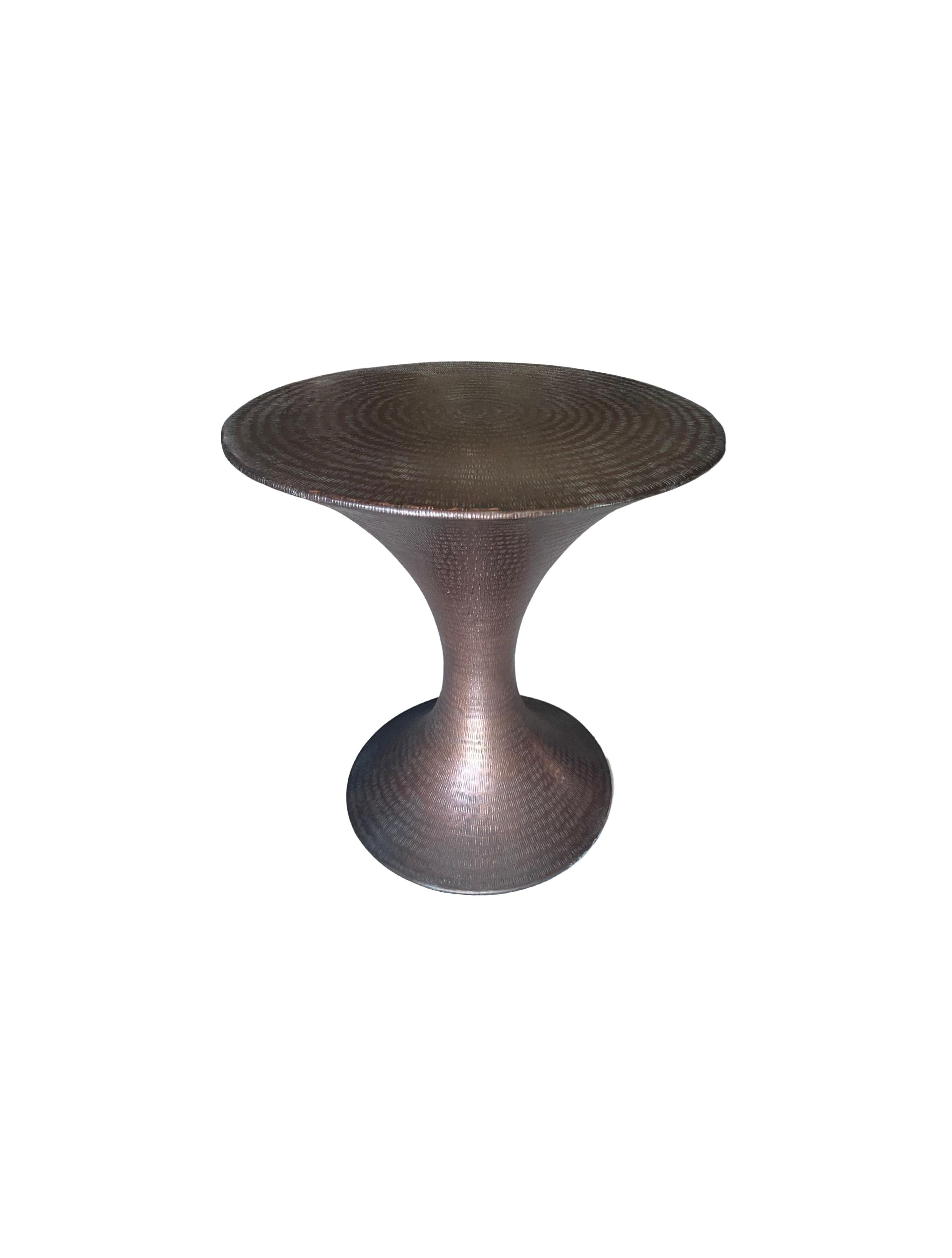 Hammered by hand this side table has a versatile aesthetic allowing it to mix easily with a wide range of spaces. The table is crafted from brass and features this wonderful detailing on all sides.