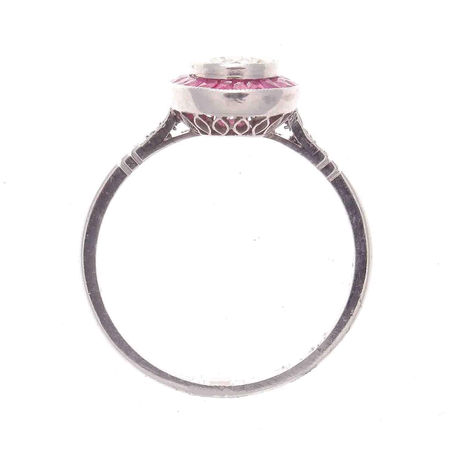A stylish recreation from the art deco era. Featuring a lively 0.65 brilliant diamond surrounded by a halo of vibrant rubies. A colorful and well made ring, lovingly hand crafted in platinum.
Ring size 6 3/4 and may easily be re-sized to fit.