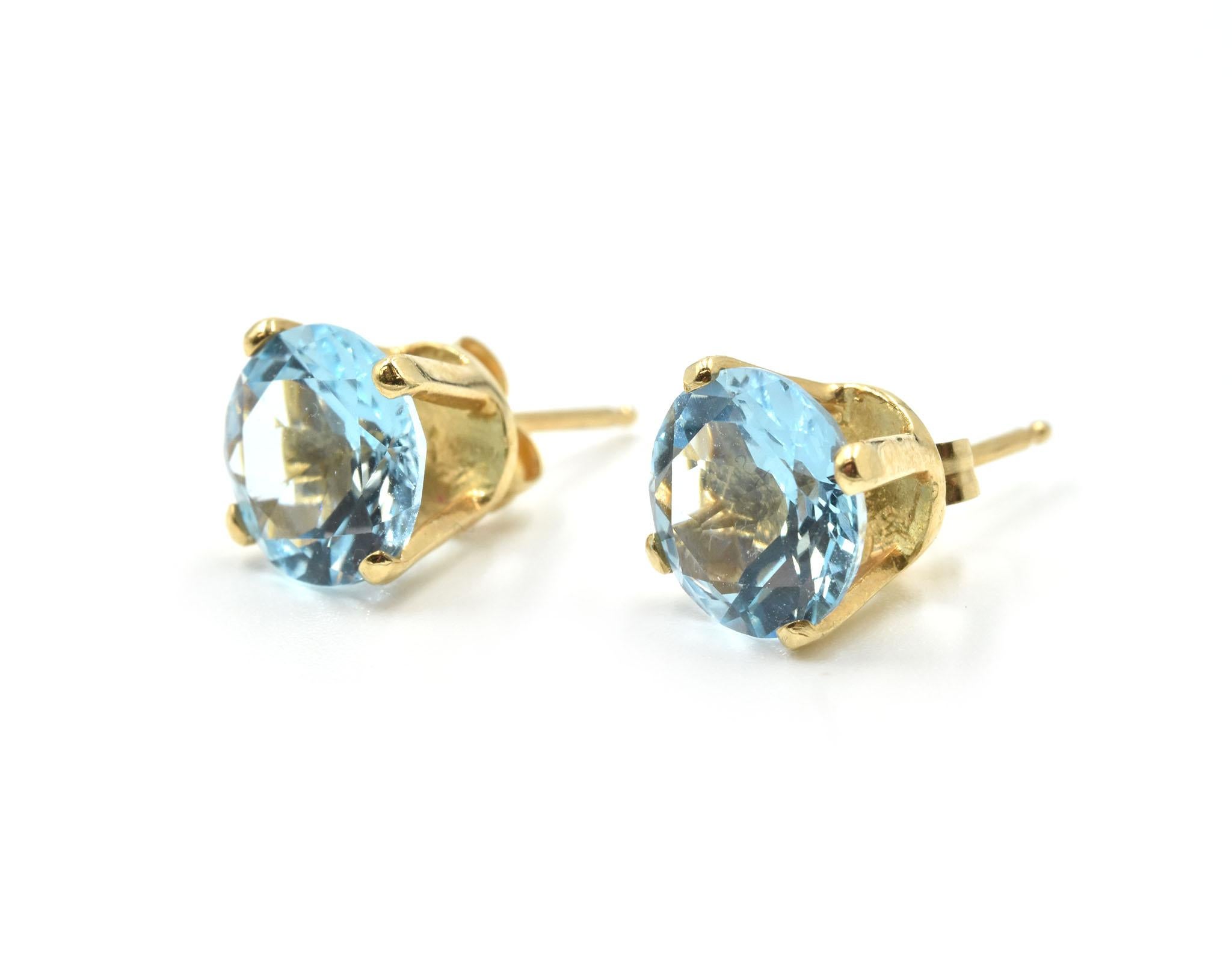 Designer: custom design
Material: 14k yellow gold
Blue Topaz: two round brilliant blue topaz = approximately 4.00 carat total weight
Fastenings: friction back fastenings
Dimensions: each earring top measures 8.00mm in diameter
Weight: 2.15 grams
