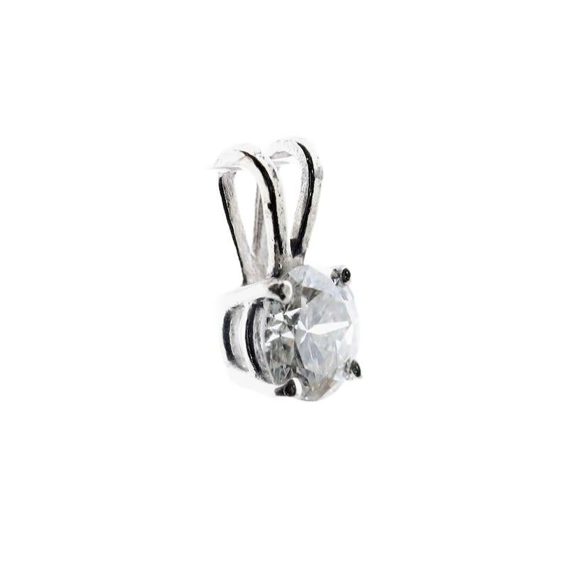 Aston Estate Jewelry Presents:

A truly timeless and classic diamond solitaire pendant. Crafted in 14 karat white gold, this pendant features a 0.53 carat round brilliant cut diamonds. The diamond is of H color with SI2 clarity.

Hallmarked as 14