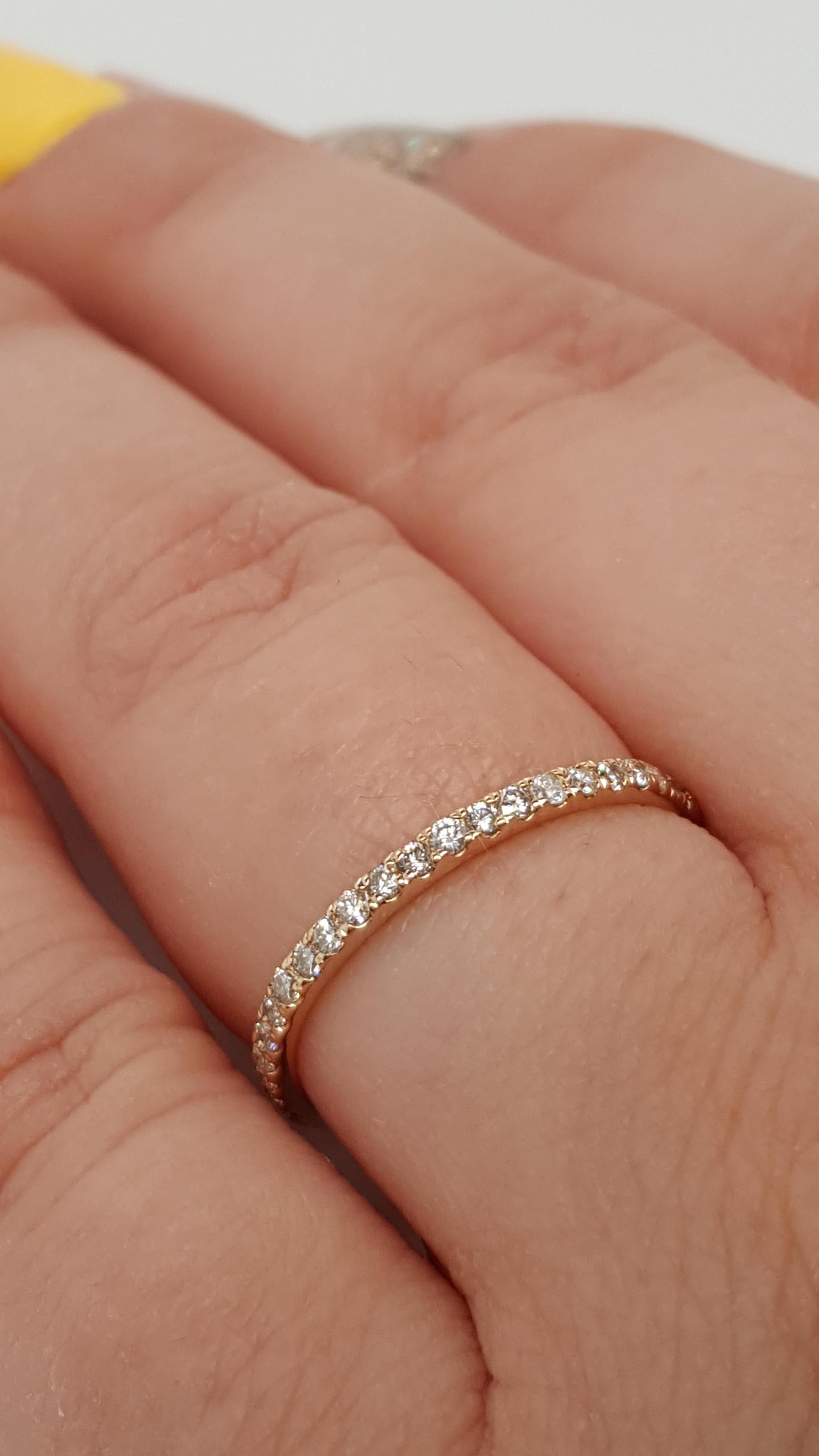 This beautiful piece contains 22 gorgeous round brilliant cut diamonds in a  row along the yellow gold band. With a dainty design on both sides of the diamonds. The total carat weight is 0.22 carat for the round cut diamonds in this ring! The