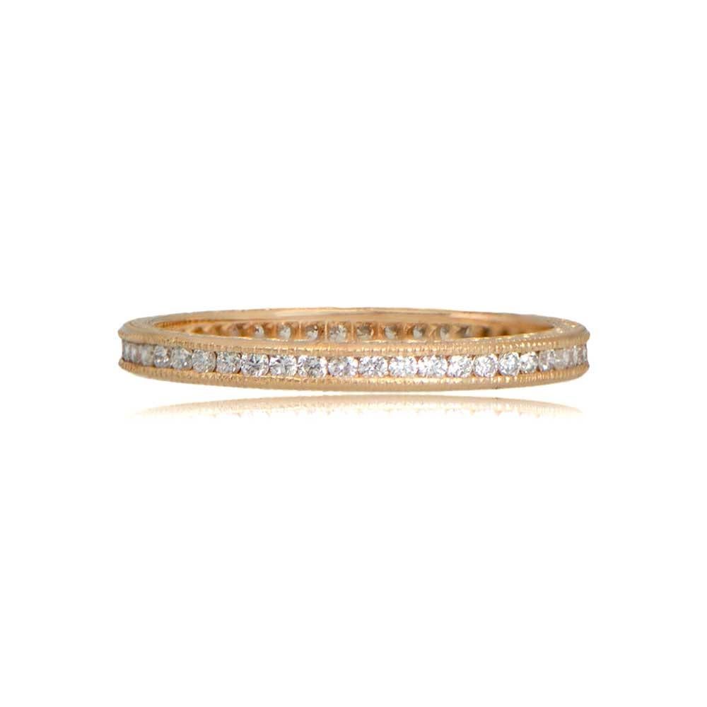 This exquisite wedding band, inspired by the French Art Deco Era, features stunning 18K yellow gold craftsmanship. Adorned with beautiful etchings along the sides, the band is a true vintage masterpiece. The diamonds, channel-set in round brilliant