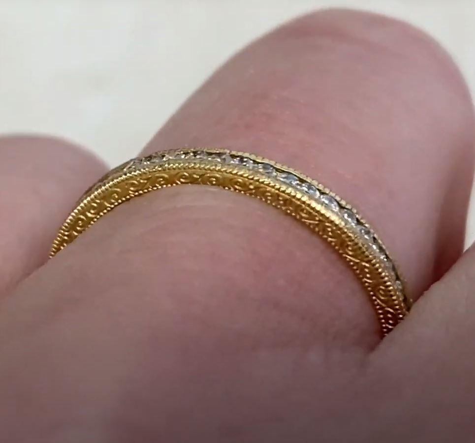 This exquisite vintage-style wedding band is expertly handcrafted in 18K yellow gold, exuding timeless elegance and sophistication. Delicate etchings adorn the sides, adding a touch of intricate artistry that enhances its antique charm. The warm