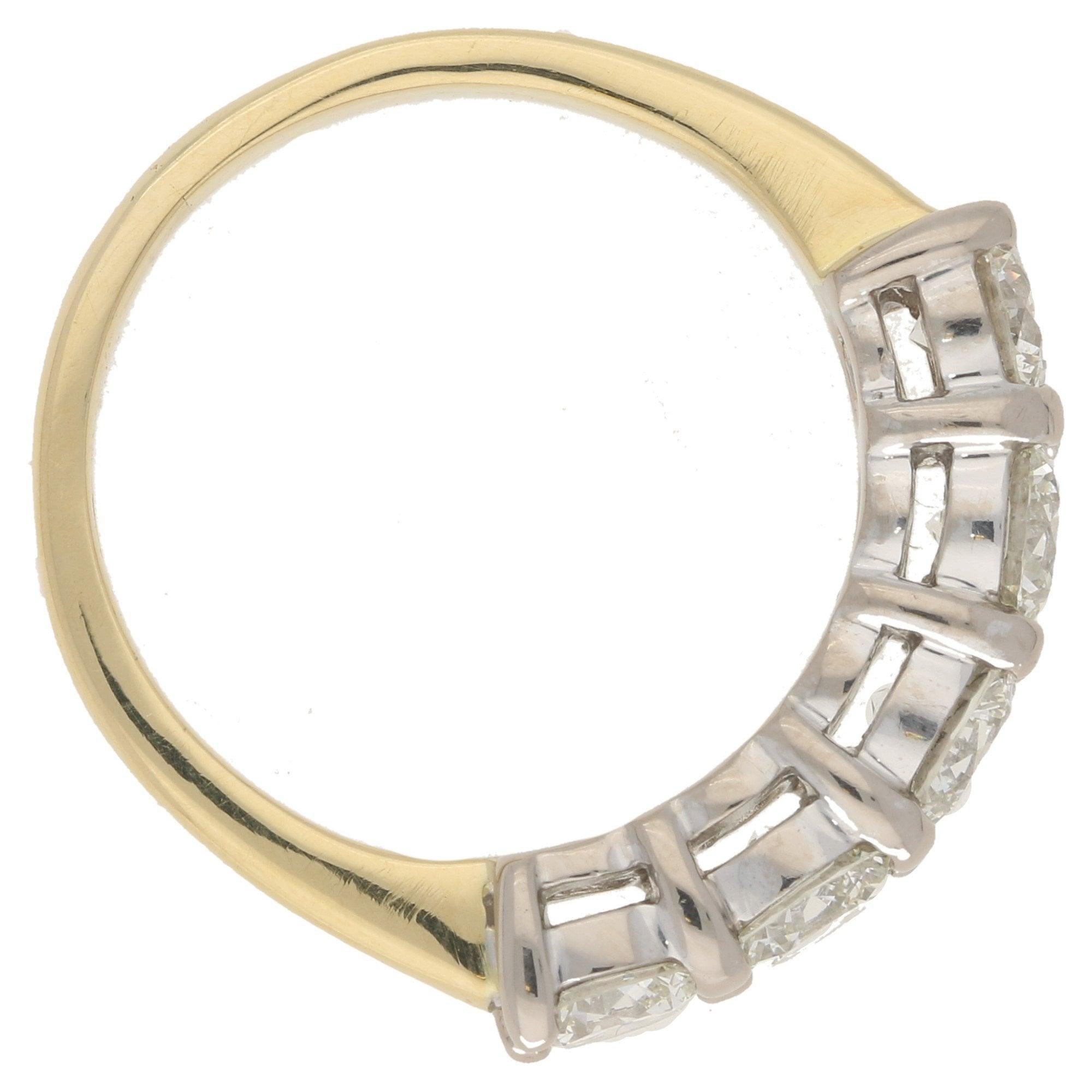A beautiful five stone diamond ring set in 18k yellow and white gold.

The piece is composed of five perfectly matched round brilliant cut diamonds. Each diamond is horizontally set in simple white gold open back shared claw setting. This then leads