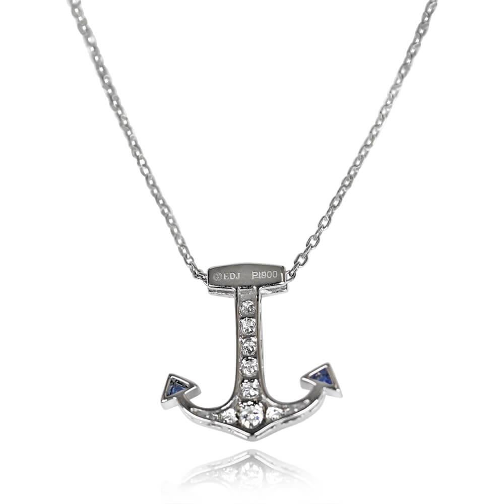 Anchored in elegance, this platinum pendant takes the form of an anchor adorned with sapphires and diamonds. The sapphires, gracefully cut in the French style, weigh approximately 0.21 carats, while the round brilliant diamonds add approximately
