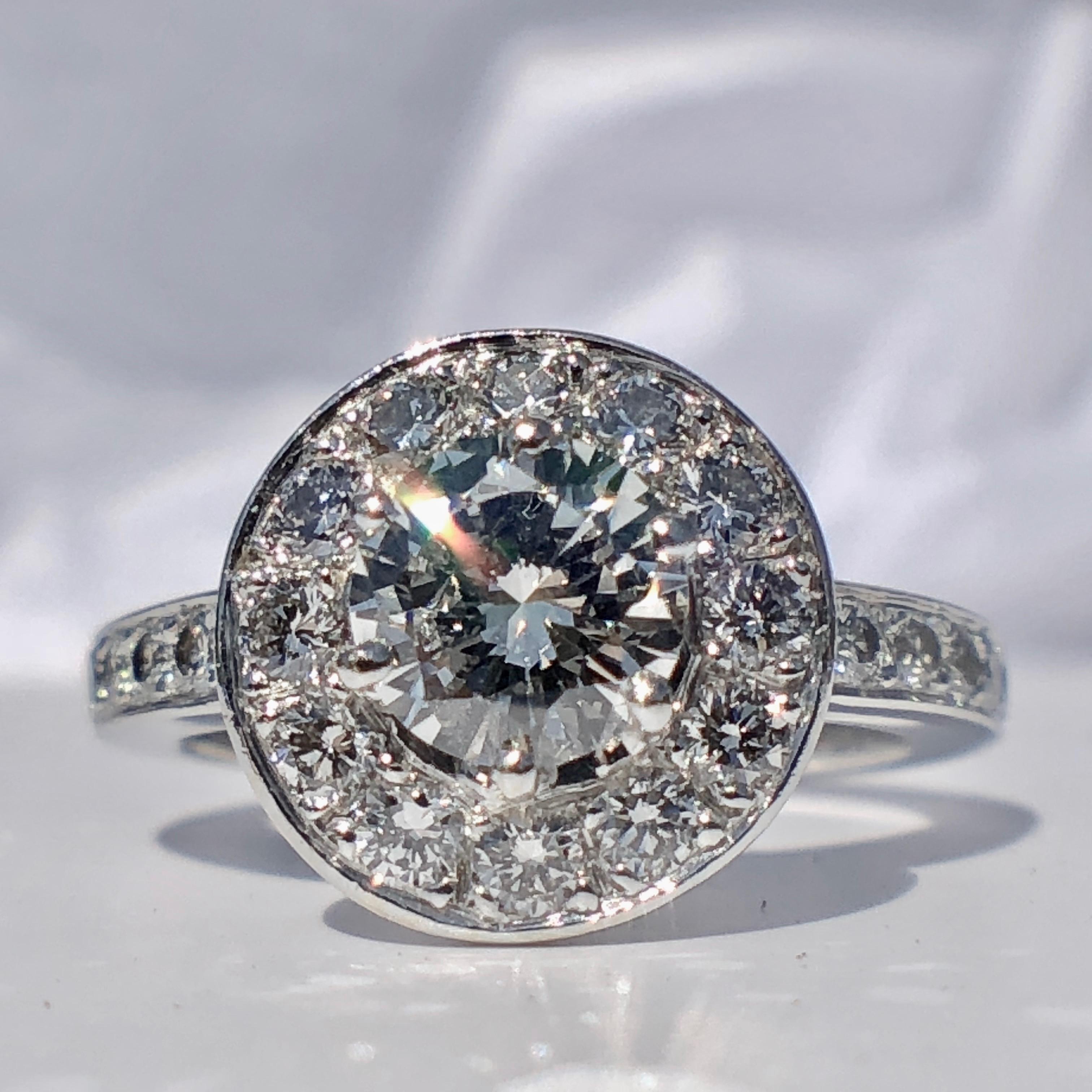 The central round brilliant cut white diamond dazzles with the most exceptional fire and sparkle, framed by more diamonds for the beautiful halo.

Simply stunning, this beautiful 18k white gold diamond halo ring is designed to sparkle. Inspired by