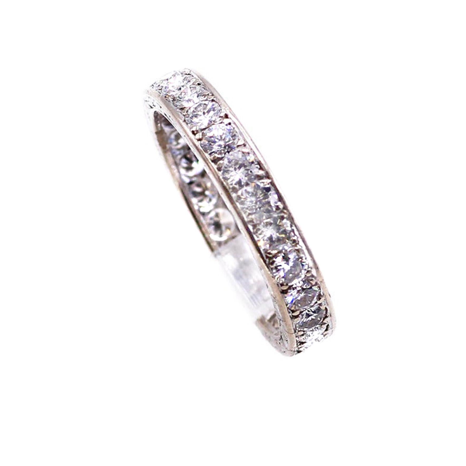 Beautiful handcrafted 18 karat white gold eternity band set with 26 bright white round brilliant cut diamonds measured to weigh approximately 1.7 carats. Average color and clarity F VS. Ring size 7.5