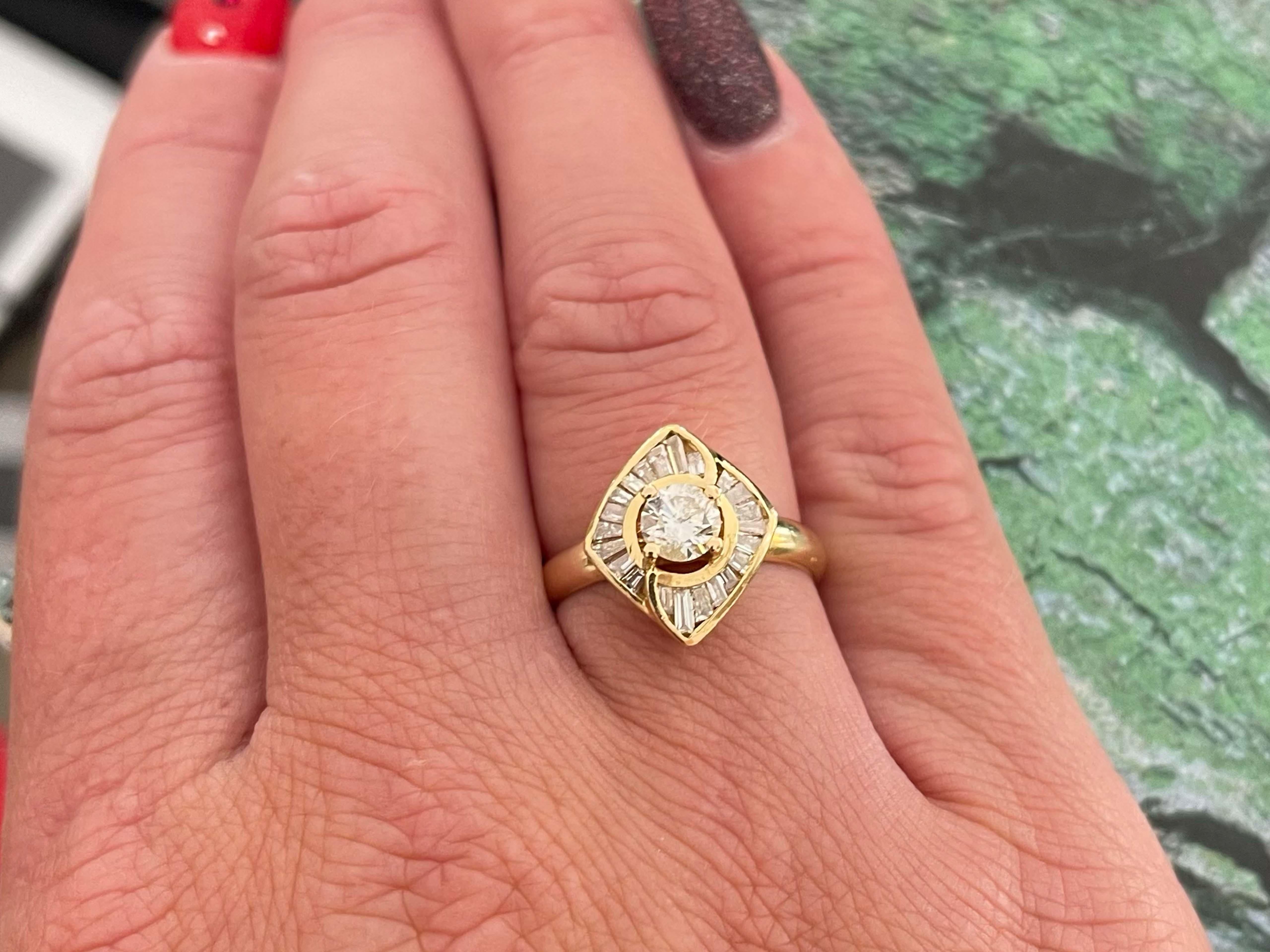 This gorgeous ring features a prong set round brilliant cut diamond in the center, H color and I1 clarity totaling 0.45 carats. Around this diamond are 22, channel set, baguette diamonds forming a diamond shape. These diamonds are H-I color and