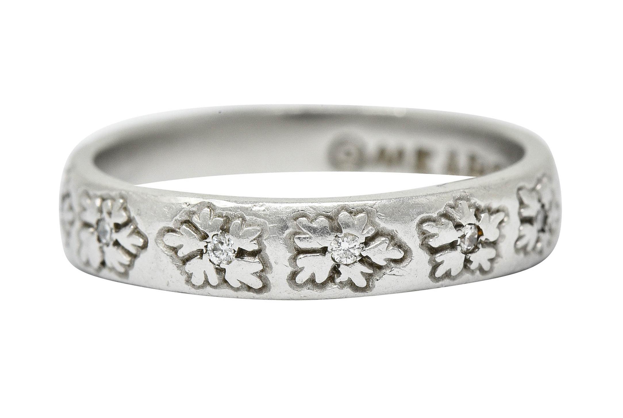 Band ring is deeply engraved fully around by a stylized floral motif

With round brilliant cut diamonds weighing in total approximately 0.18 carat - eye clean and white

Stamped PLAT for platinum

Fully signed Me & Ro

Circa: 2000s

Ring Size: 6 1/2