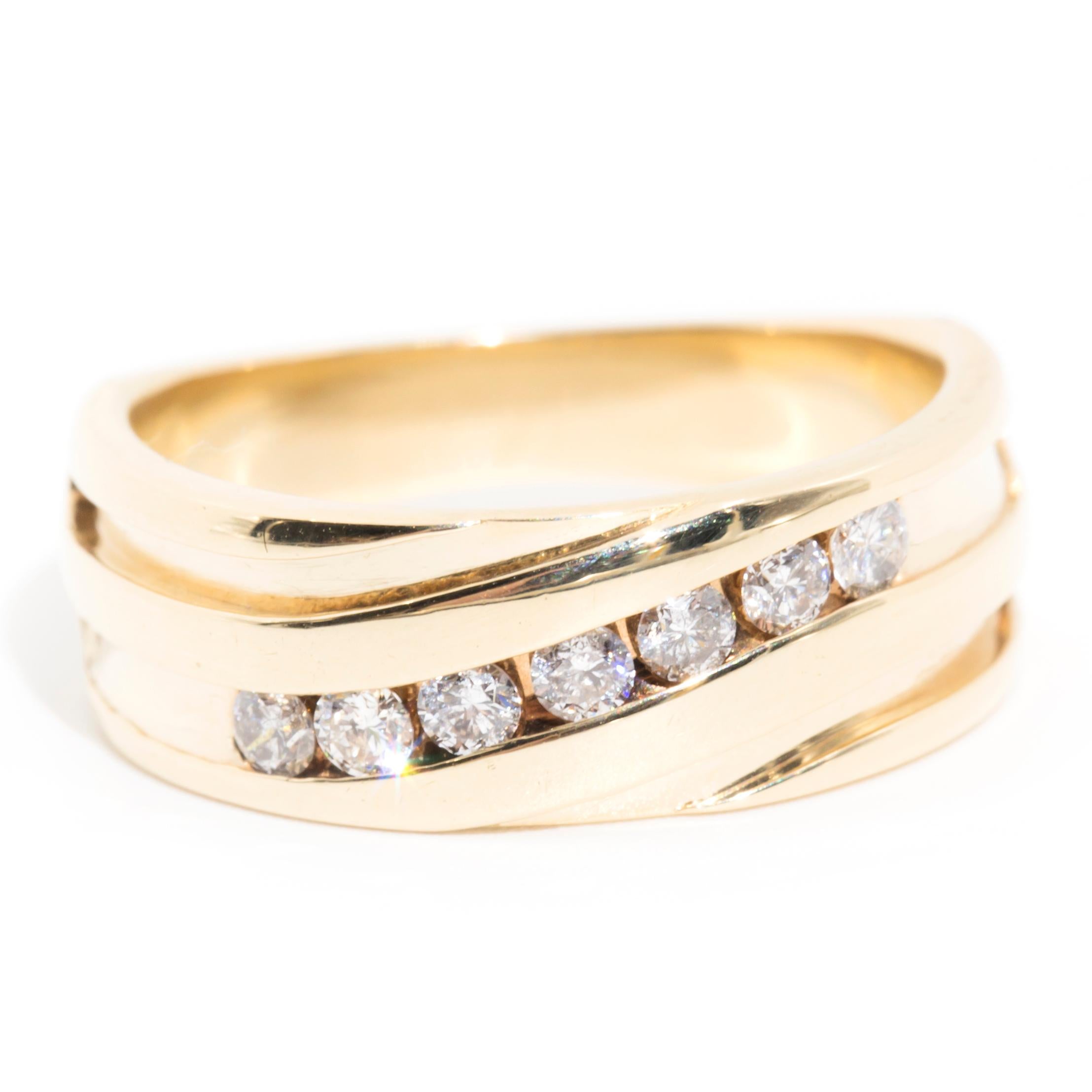 Crafted in 9 carat yellow gold, this handsome band ring features a central channel embellished with seven glittering round brilliant cut diamonds. We have named this dapper vintage piece The Gretchen Band. Her charming design lends her to be