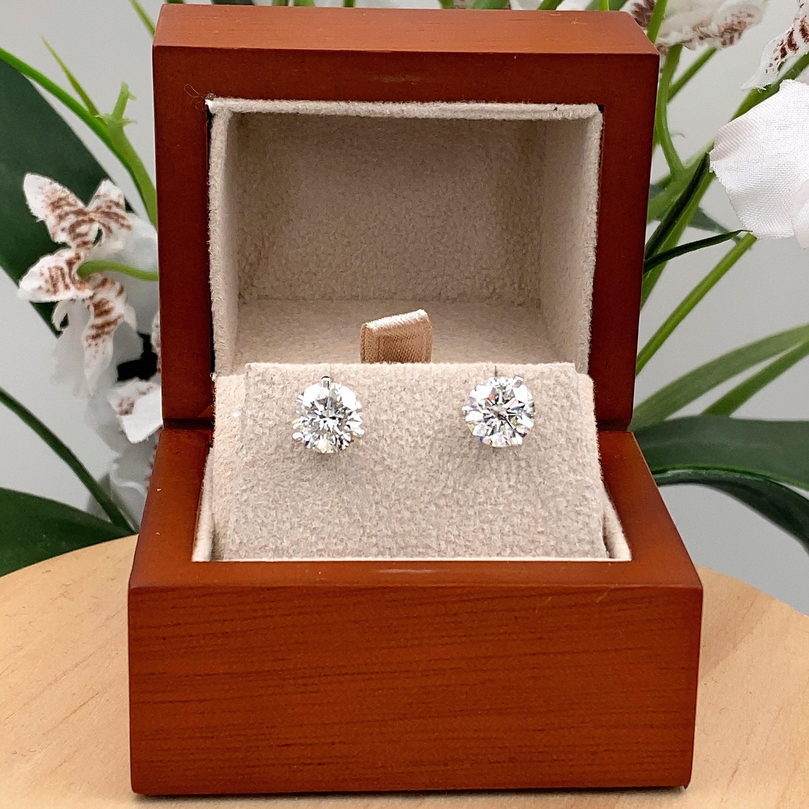 Brand New Round Brilliant Diamond Stud Earrings
Style:  Martini Set
Metal:  14kt White Gold
Size:  Medium
TCW:  3.17 tcw
Main Diamond:  2 Round Brilliant Diamonds 1.56 cts & 1.61 cts
Color & Clarity:  H - I, I1  
Hallmark:  585
Includes:  Certified