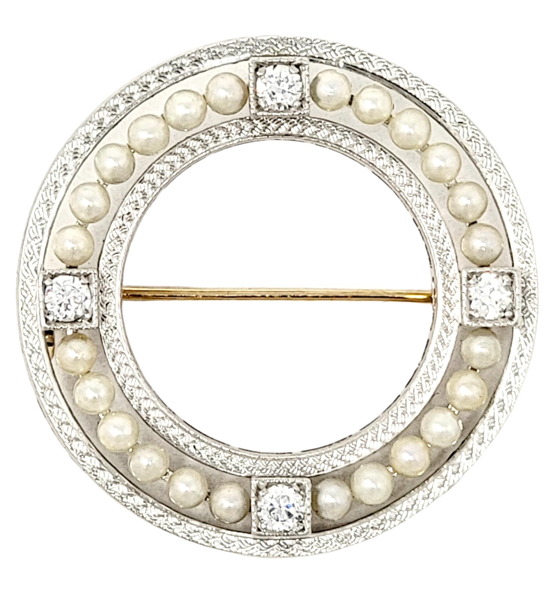 Simple yet elegant platinum circle brooch with herringbone detail, accented by delicate seed pearls and natural glittering diamonds. 

Metal: Platinum and 14K Yellow Gold
Closure: Hinged stick pin
Seed Pearls: 24
Natural Diamonds: .25 ctw 
Diamond