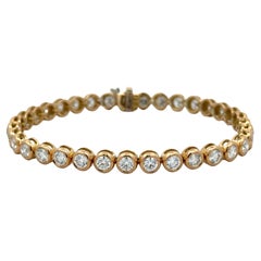 Bracciale da tennis con lunetta di diamanti tondi e brillanti 5,70 carati in oro giallo 18 carati