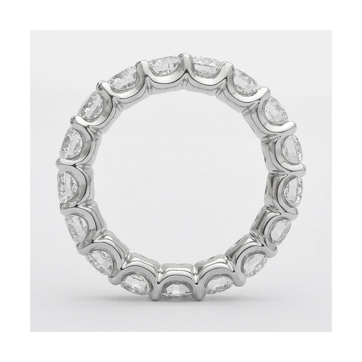 Diamond eternity band ring, showcasing fine near-colorless round brilliant-cut diamonds prong-set in a platinum mounting with a 'U'-shaped sculpted-edge.

Sixteen diamonds weighing 3.69 total carats (G-color and VS2 clarity, or better)
Designed by