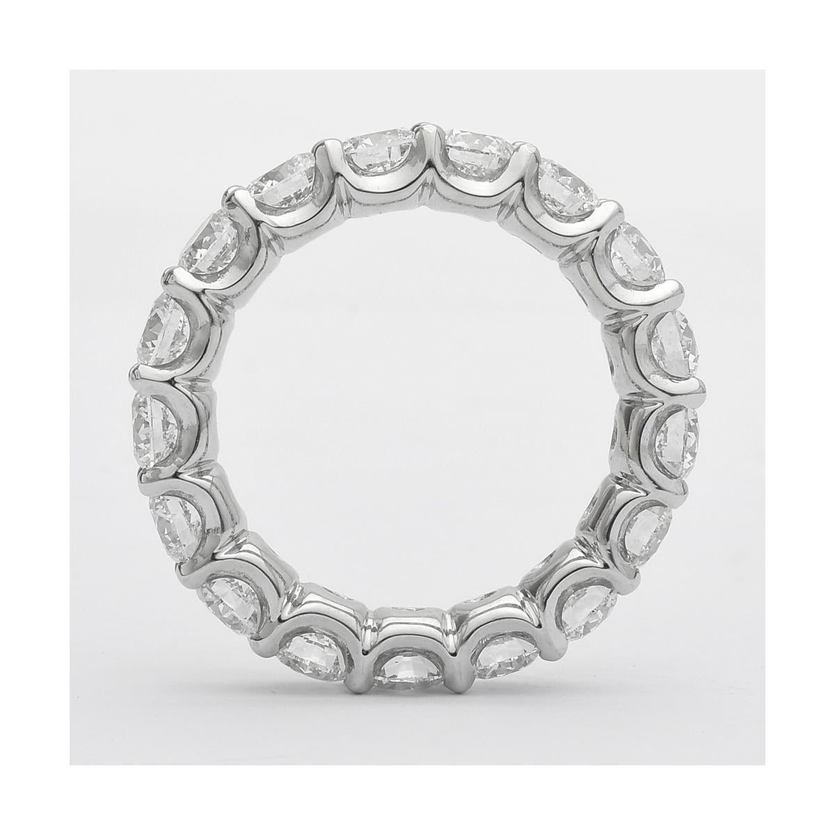 Diamond eternity band ring, showcasing fine near-colorless round brilliant-cut diamonds prong-set in a platinum mounting with a 'U'-shaped sculpted-edge.

Seventeen diamonds weighing 4.06 total carats
Size 5.75