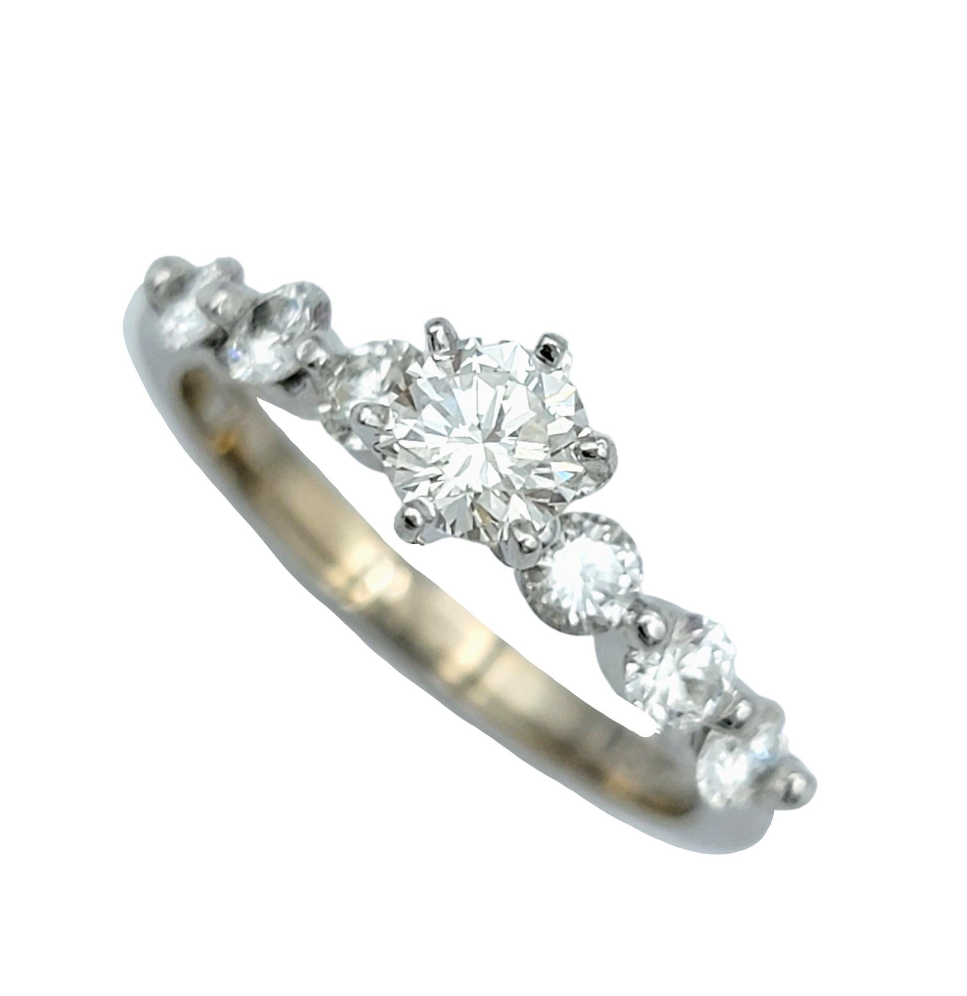 Ring Size: 7

This elegant and refined round diamond engagement ring exudes timeless sophistication, set delicately in shimmering 14 karat white gold. At its focal point sits a resplendent center diamond, gracefully elevated above the finger,