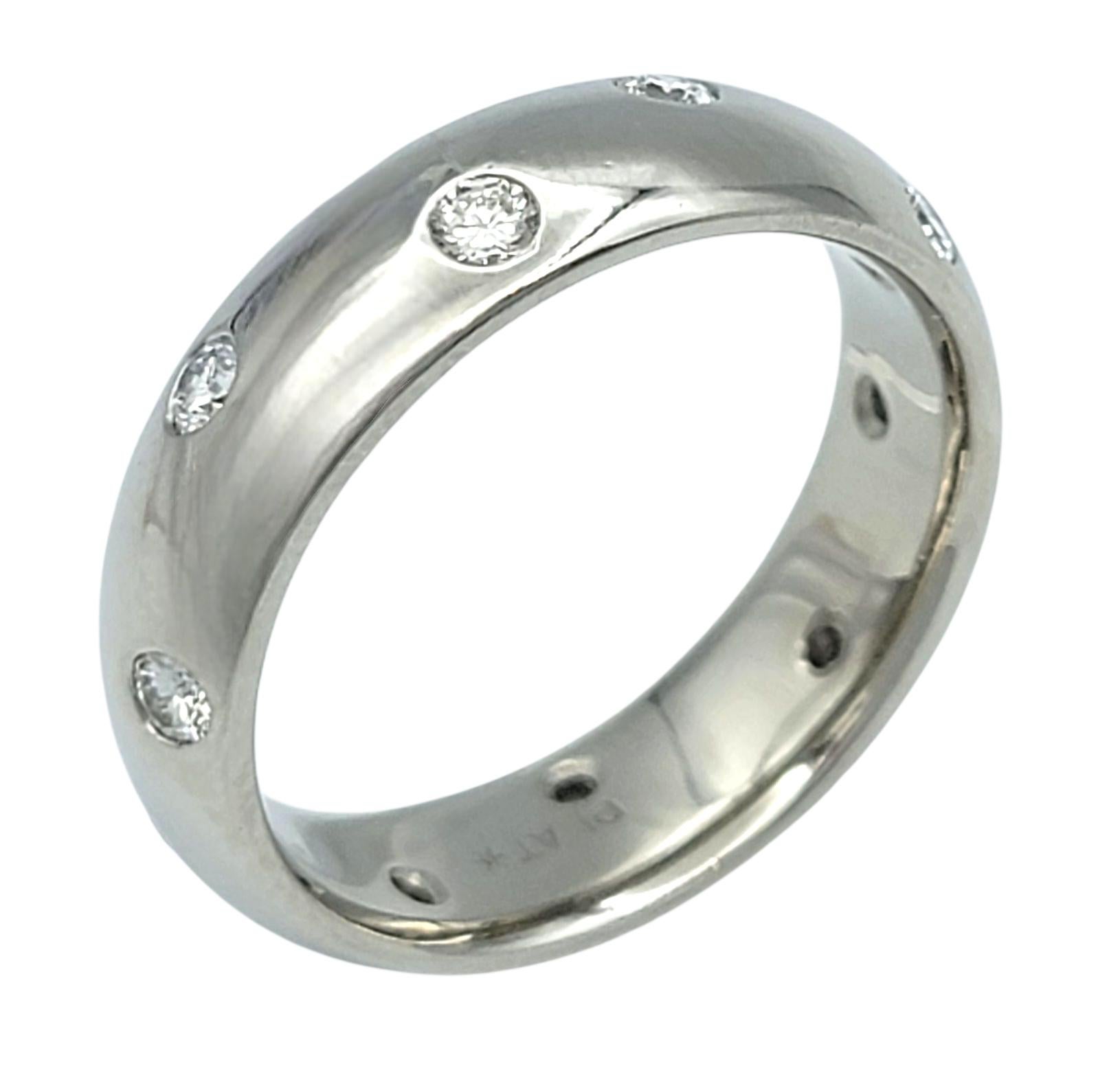 Ring Size: 7.75

This striking platinum ring is beautifully accented by shimmering round brilliant diamonds. The diamonds are set flush into the polished platinum, creating a sleek and modern aesthetic with subtle sparkle. Its streamlined form make