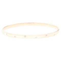 Round Brilliant Diamond Hammer Set Solid Oval Bangle in 9 Carat Yellow Gold
