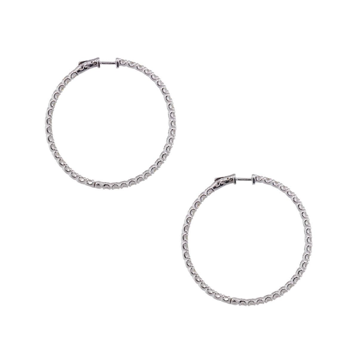 Material: 14k white gold
Diamond Details: Approximately 6.22tw of round brilliant diamonds. Diamonds are G/H in color and VS in clarity.
Measurements: 2″ 0.13″ x 2″
Earrings Backs: Hoop
Total Weight: 17.3g (11.1dwt)
Additional Details: This item