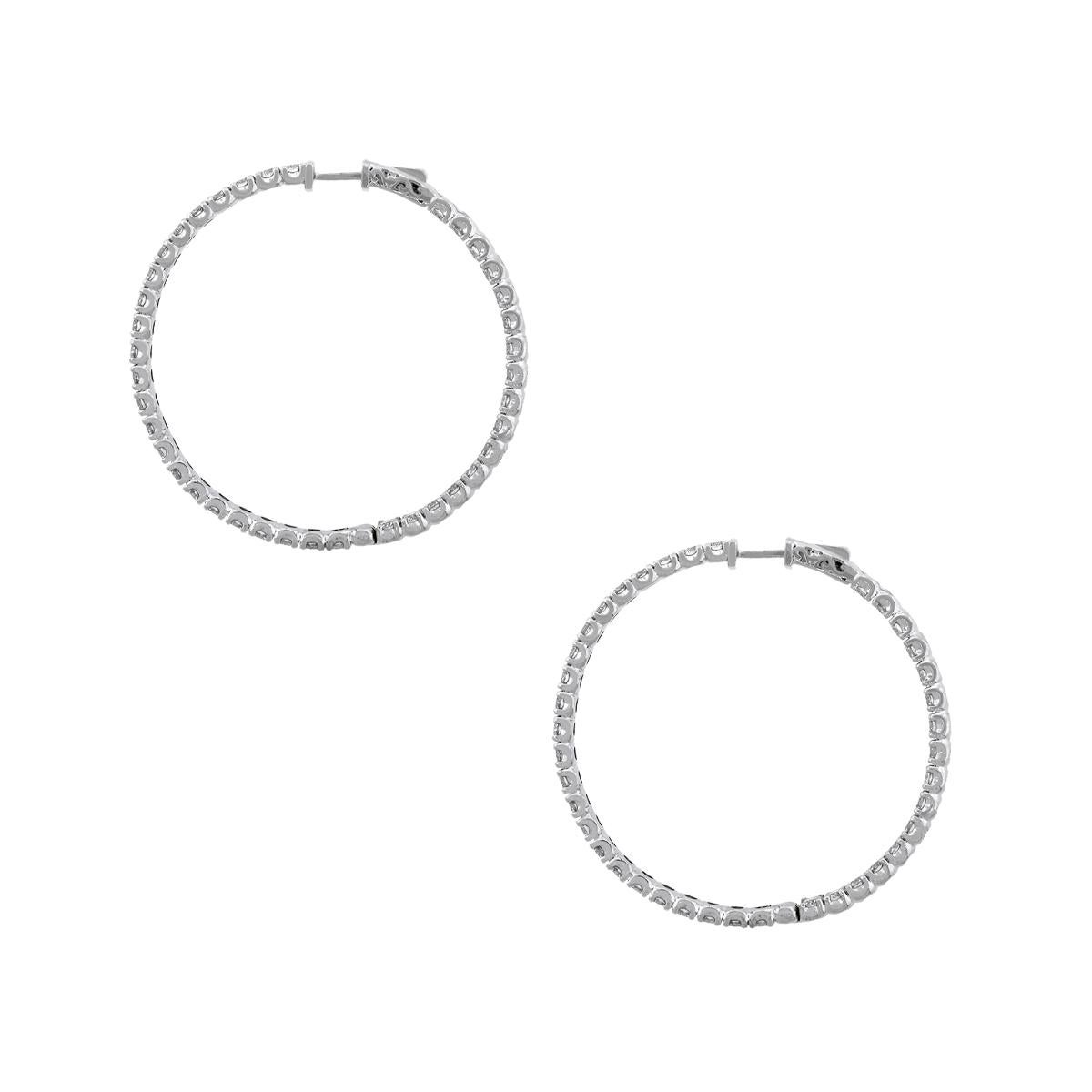 Material: 14k white gold
Style: Diamond inside out hoop earrings
Diamond Details: 78 Stones, approximately 9.01ctw of round brilliant diamonds. Diamonds are G/H in color and VS in clarity.
Earring Measurements: 1.88″ x 0.15″ x 1.96″
Total Weight: