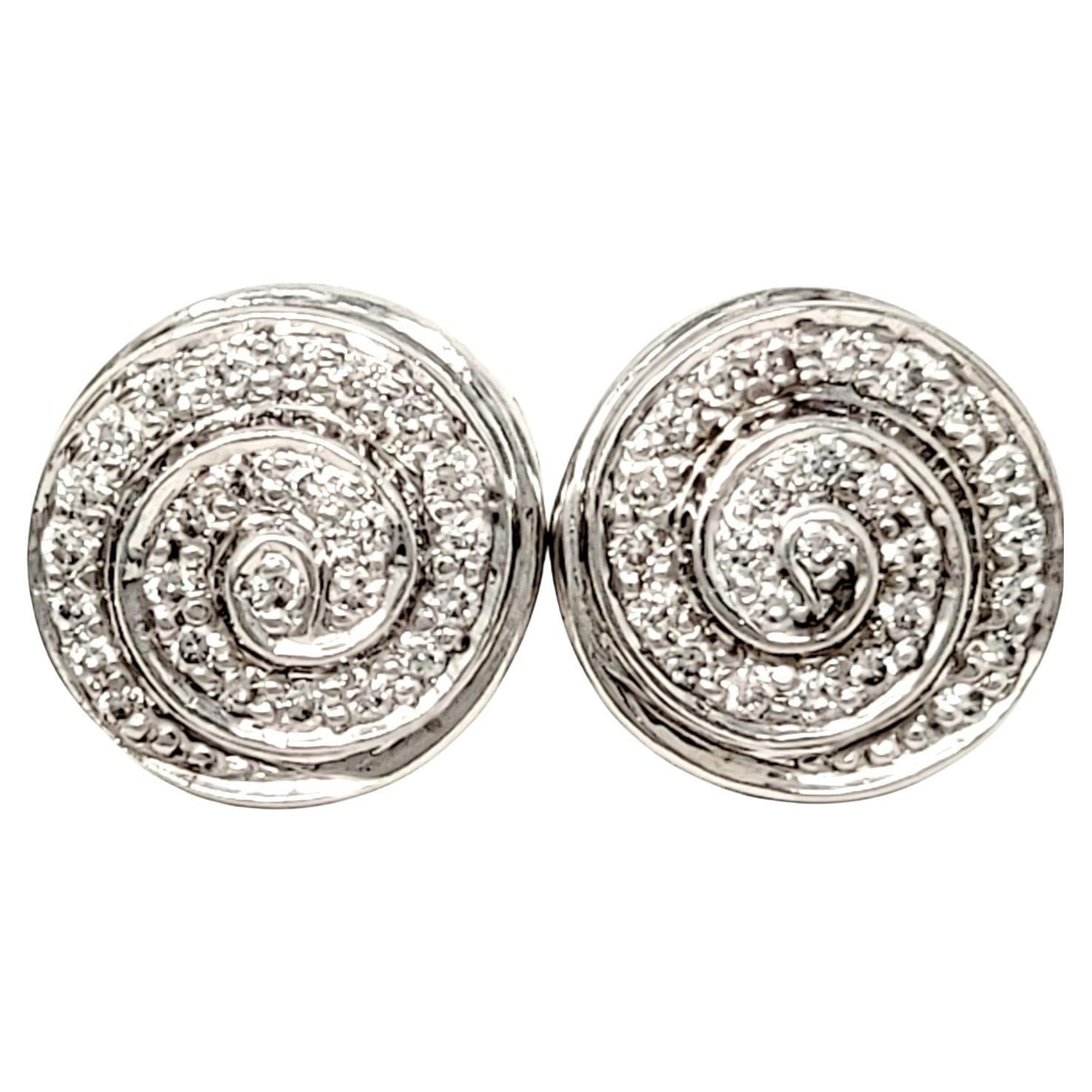 Beautiful diamond stud earrings with a unique modern twist. The sparkling natural stones are set in polished white gold and arranged in a nautilus design, allowing the glittering diamonds to swirl and sparkle from every angle.

Earring type:
