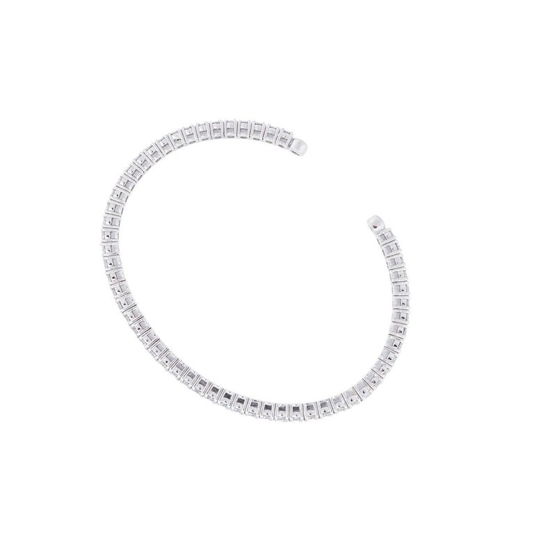 Material: 14k white gold
Diamond Details: Approximately 5.20ctw of white round brilliant diamonds. Diamonds are G/H in color and VS in clarity.
Measurements: Will fit a 6″ wrist
Clasp: Open
Item Weight: 14.1g (9dwt)
Additional Details: This item