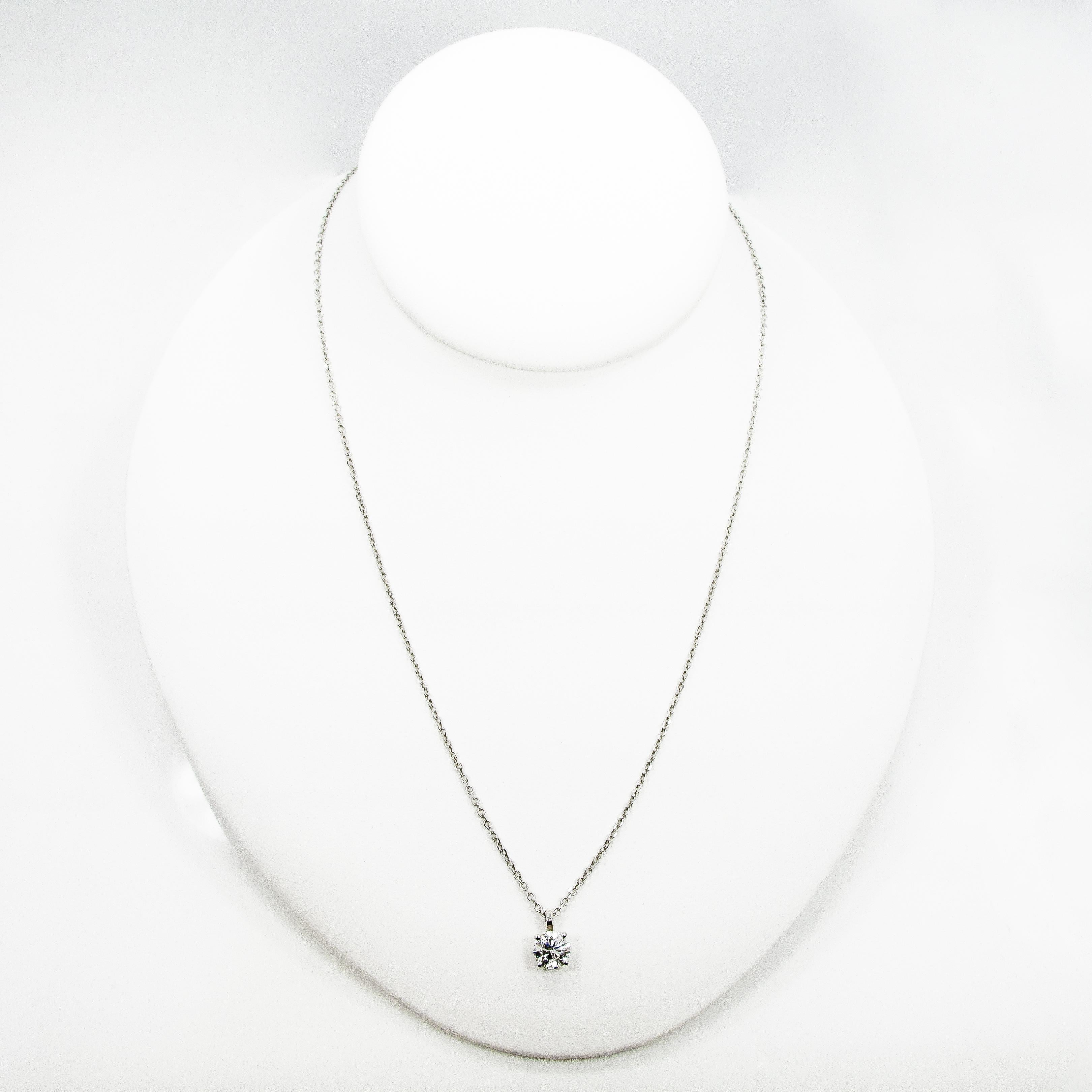 One round brilliant diamond pendant set in a 14k white gold open gallery basket. The diamond weighs 1.16ct and measures 6.75mm. The stone is F in color, I1 in clarity. The basket hangs from a simple bale on a 16 inch 14k white gold cable chain (with
