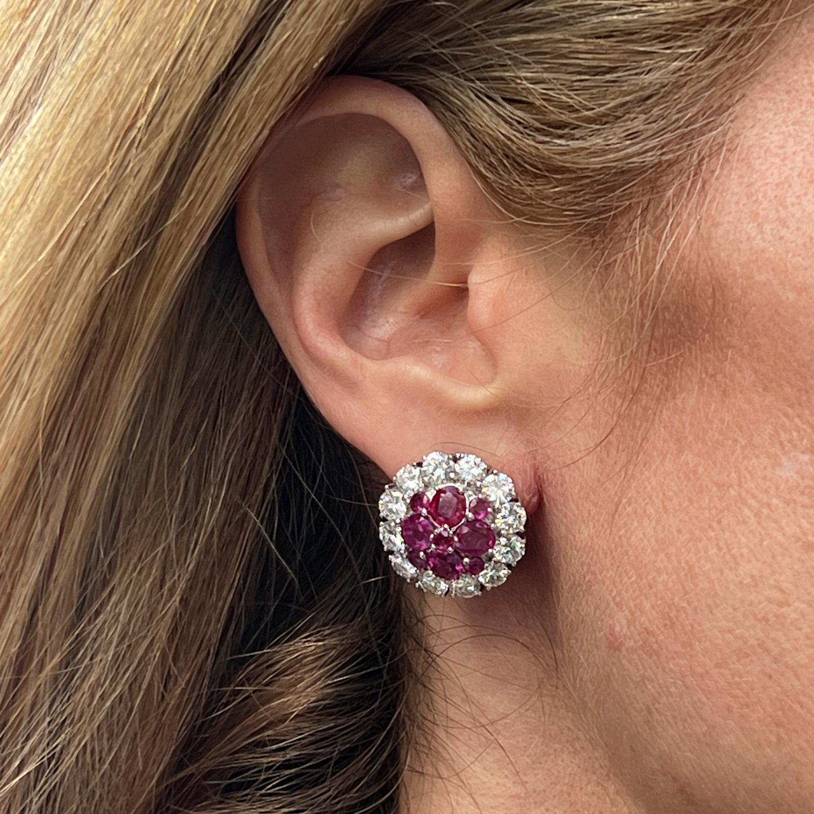Spectacular diamond and ruby circle earrings crafted in 18 karat white gold. The earrings feature 24 round brilliant cut diamonds weighing approximatley 6.00 carat total weight and graded F-G color and VS clarity. The 18 red round natural rubies