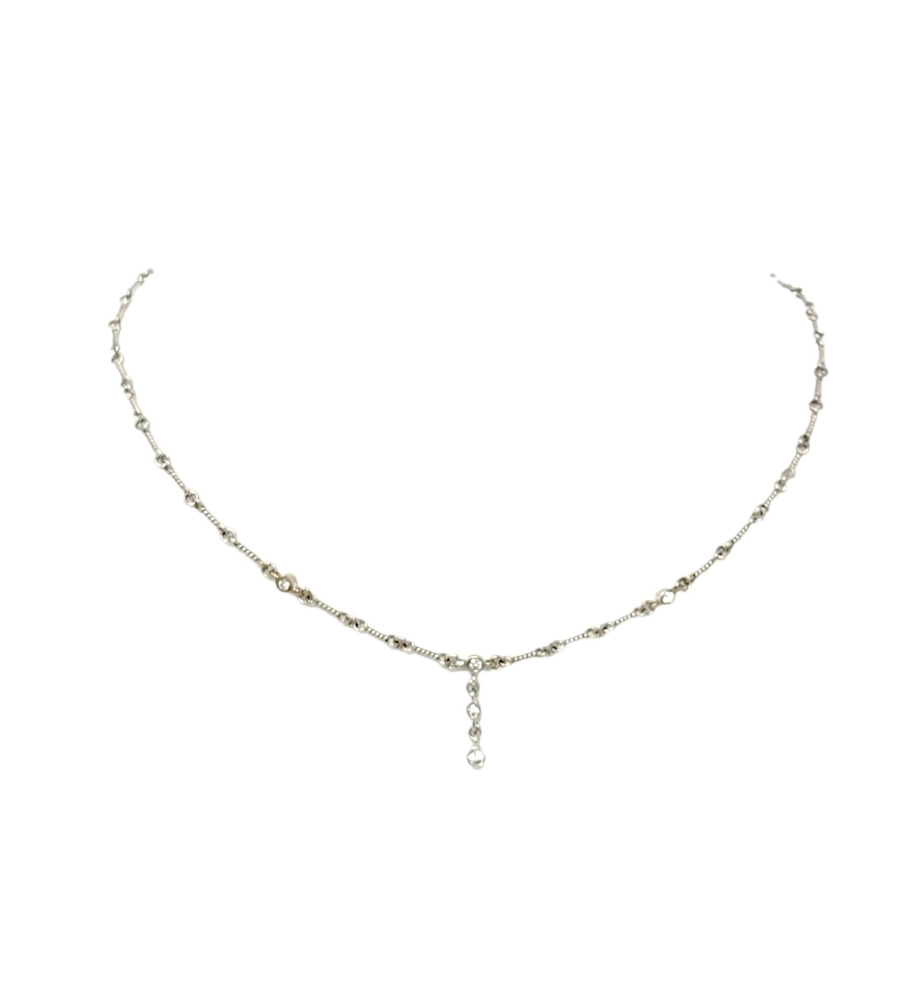 This absolutely beautiful diamond drop necklace is simple but elegant. Featuring a delicate twisted chain and a sparkling graduated drop of natural round diamonds, this lovely necklace goes with just about everything. It features 5 bezel set round
