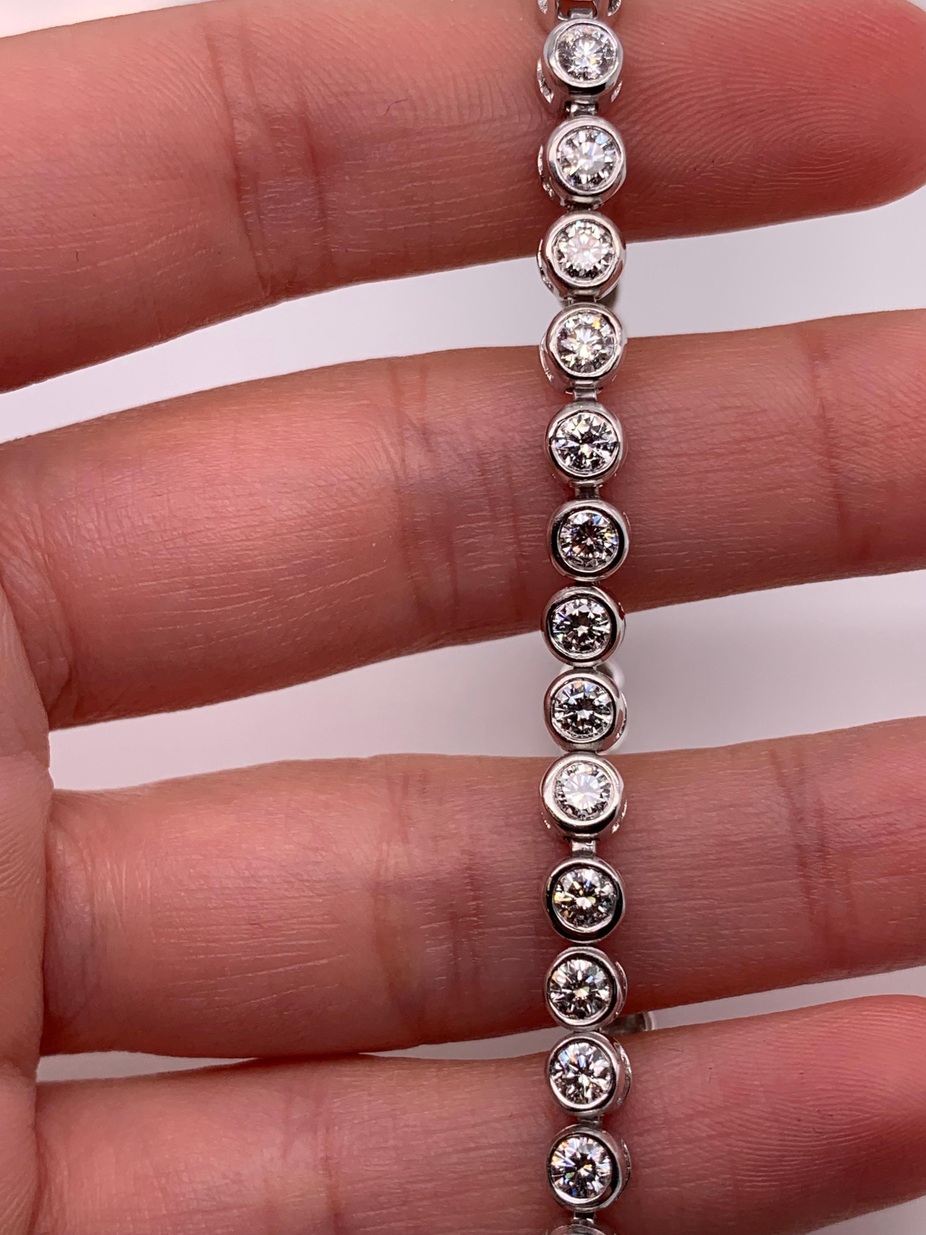 Art Deco Round brilliant diamond tennis bracelet bezel rubover 18k white gold For Sale